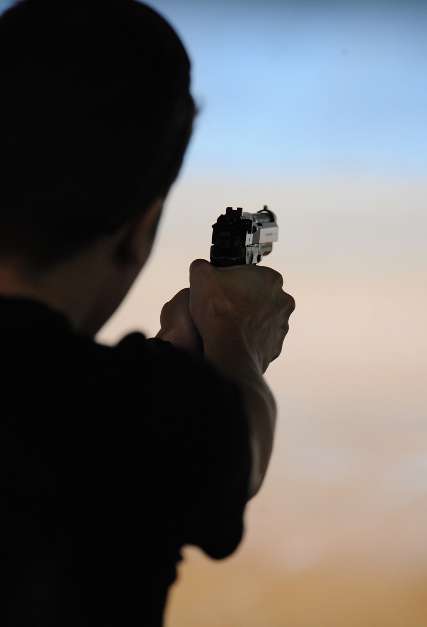 A shooter fires at a target during National Police Week activities at Cannon Air Force Base, N.M., May 13, 2013. National Police Week is an observance held to honor law enforcement officials for their sacrifices and hard work. (U.S. Air Force photo/Senior Airman Ericka Engblom) 