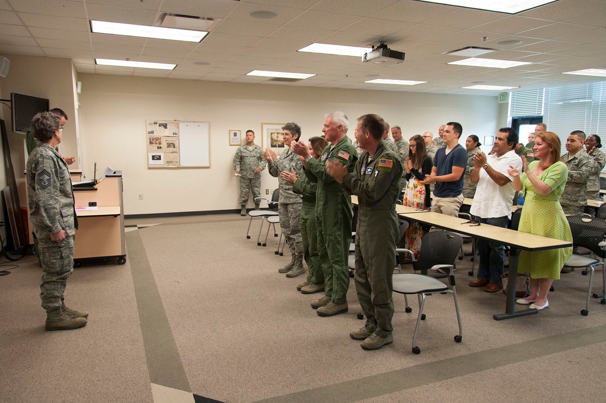 TRAVIS AIR FORCE BASE, Calif. -- Chief Master Sgt. Laura Nepute pins-on her chief new rank insignia.  Nepute was promoted in a ceremony at Travis Air Force Base, Calif., May 5, 2013 attended by members of the 349th Aeromedical Evacuation Squadron and well wishers. (U.S. Air Force photo / Lt. Col. Robert Couse-Baker)