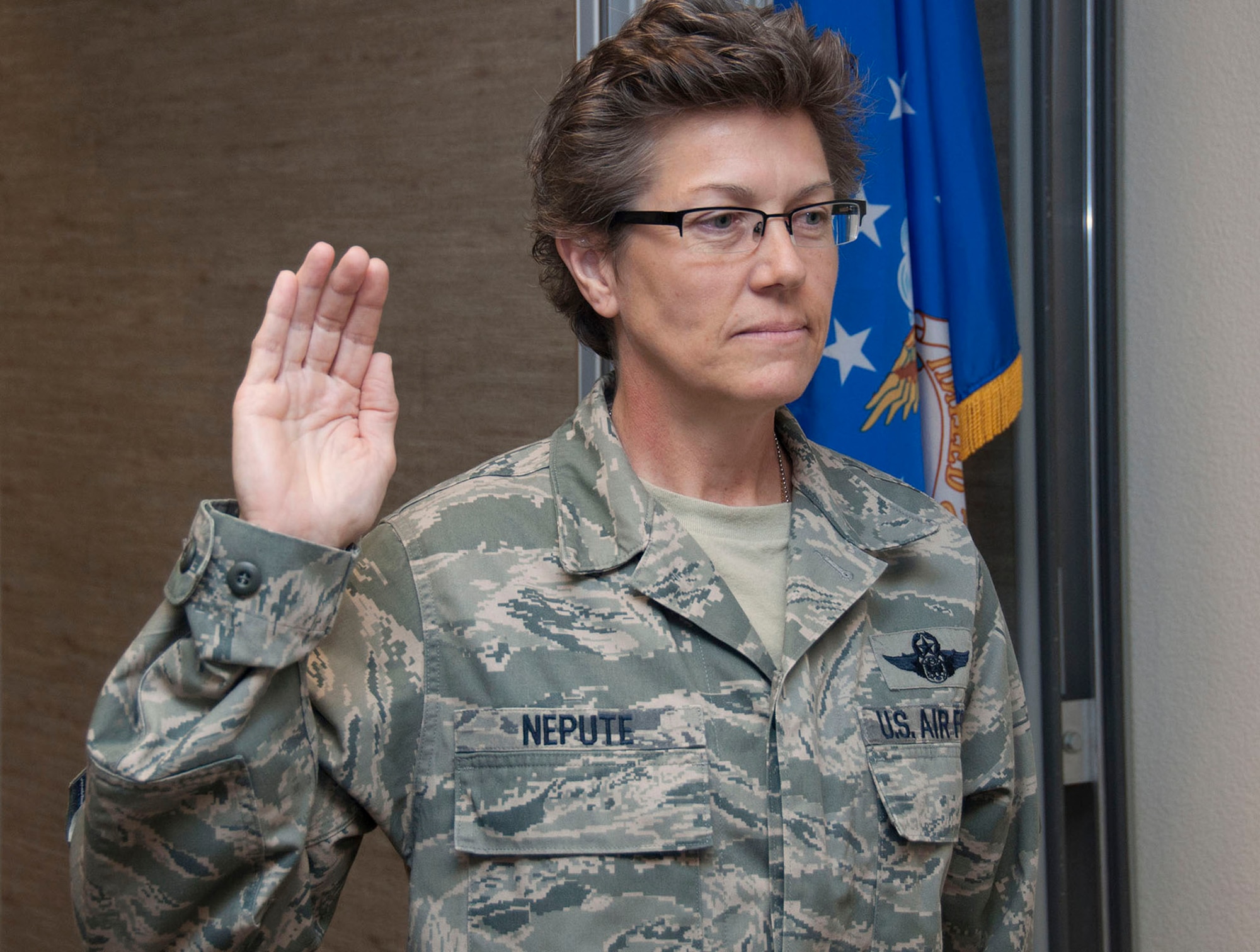 TRAVIS AIR FORCE BASE, Calif. -- Chief Master Sgt. Laura Nepute pins-on her chief new rank insignia.  Nepute was promoted in a ceremony at Travis Air Force Base, Calif., May 5, 2013 attended by members of the 349th Aeromedical Evacuation Squadron and well wishers. (U.S. Air Force photo / Lt. Col. Robert Couse-Baker)