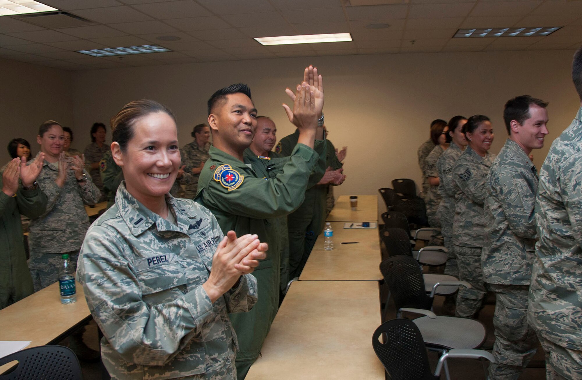 TRAVIS AIR FORCE BASE, Calif. -- Chief Master Sgt. Laura Nepute pins-on her chief new rank insignia.  Nepute was promoted in a ceremony at Travis Air Force Base, Calif., May 5, 2013 attended by members of the 349th Aeromedical Evacuation Squadron and well wishers. (U.S. Air Force photo / Lt. Col. Robert Couse-Baker)