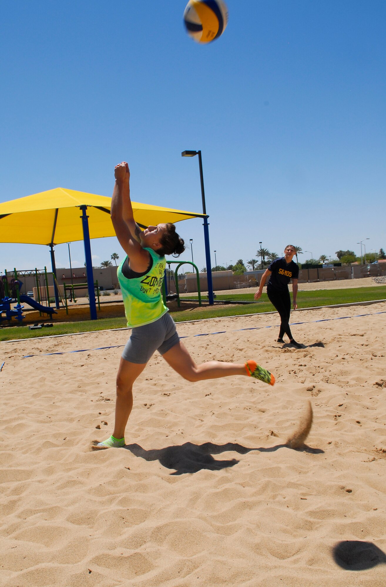 Angela White, 56th Maintenance Operations Squadron, hits the ball over the net during the first game of the 3-on-3 sand volleyball championship game May 9 at the Balfour Beatty Community Center sand volleyball court. MOS scored a point on the play. The 56th Security Forces Squadron team won the game 25-16. (U.S. Air Force photo/Senior Airman David Owsianka)