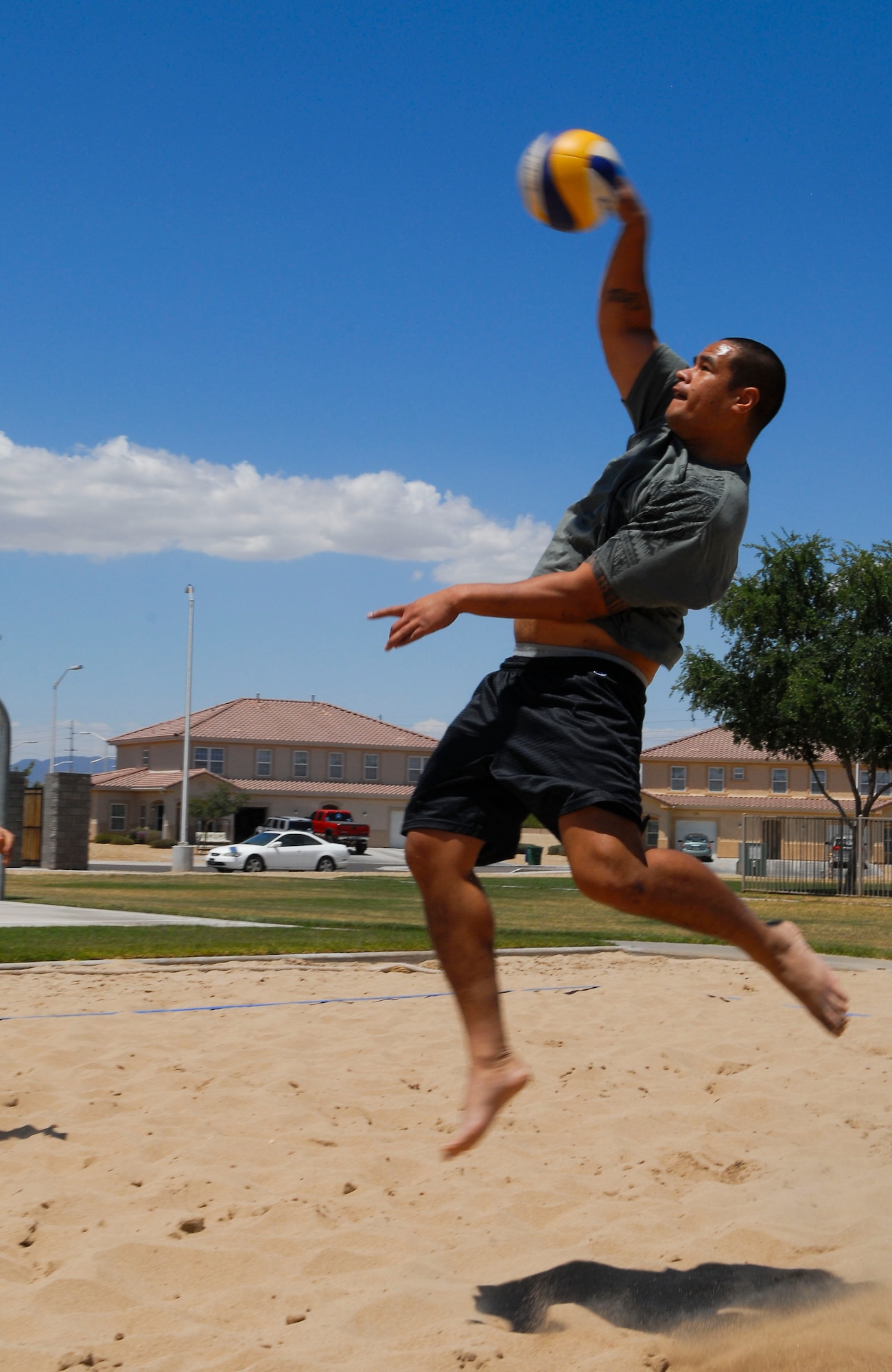 Burt Tagaloa, 56th Security Forces Squadron, hits the ball during the second game of the 3-on-3 sand volleyball championship game May 9 at the Balfour Beatty Community Center sand volleyball court. Tagaloa’s shot went too low and was stopped by the net. SFS won the game 25-22. (U.S. Air Force photo/Senior Airman David Owsianka)