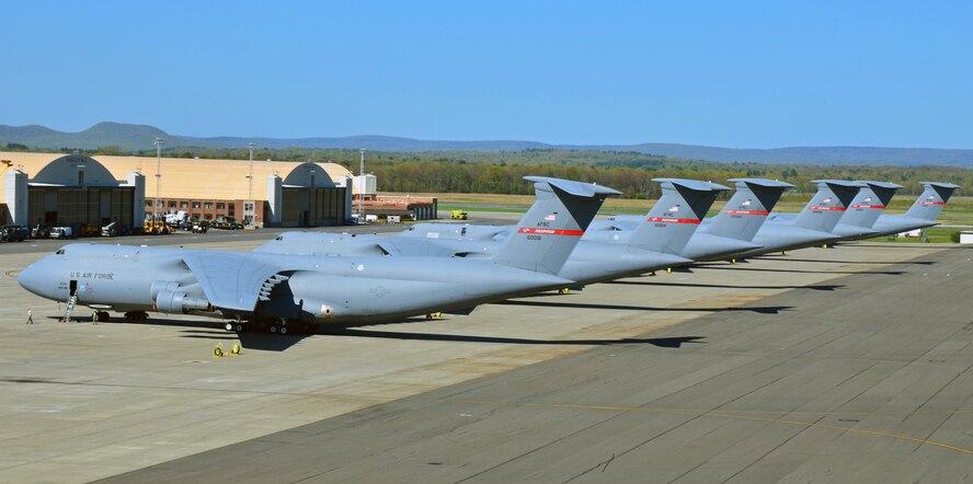 A row of C-5 Galaxy aircraft line the flight line at Westover Air Force Reserve Base in Chicopee, Mass. on June 7, 2013. Westover is the nation's largest Air Force Reserve base, and is home to the Air Force's largest cargo aircraft, the C-5 Galaxy. (U.S. Air Force photo/SrA. Kelly Galloway)