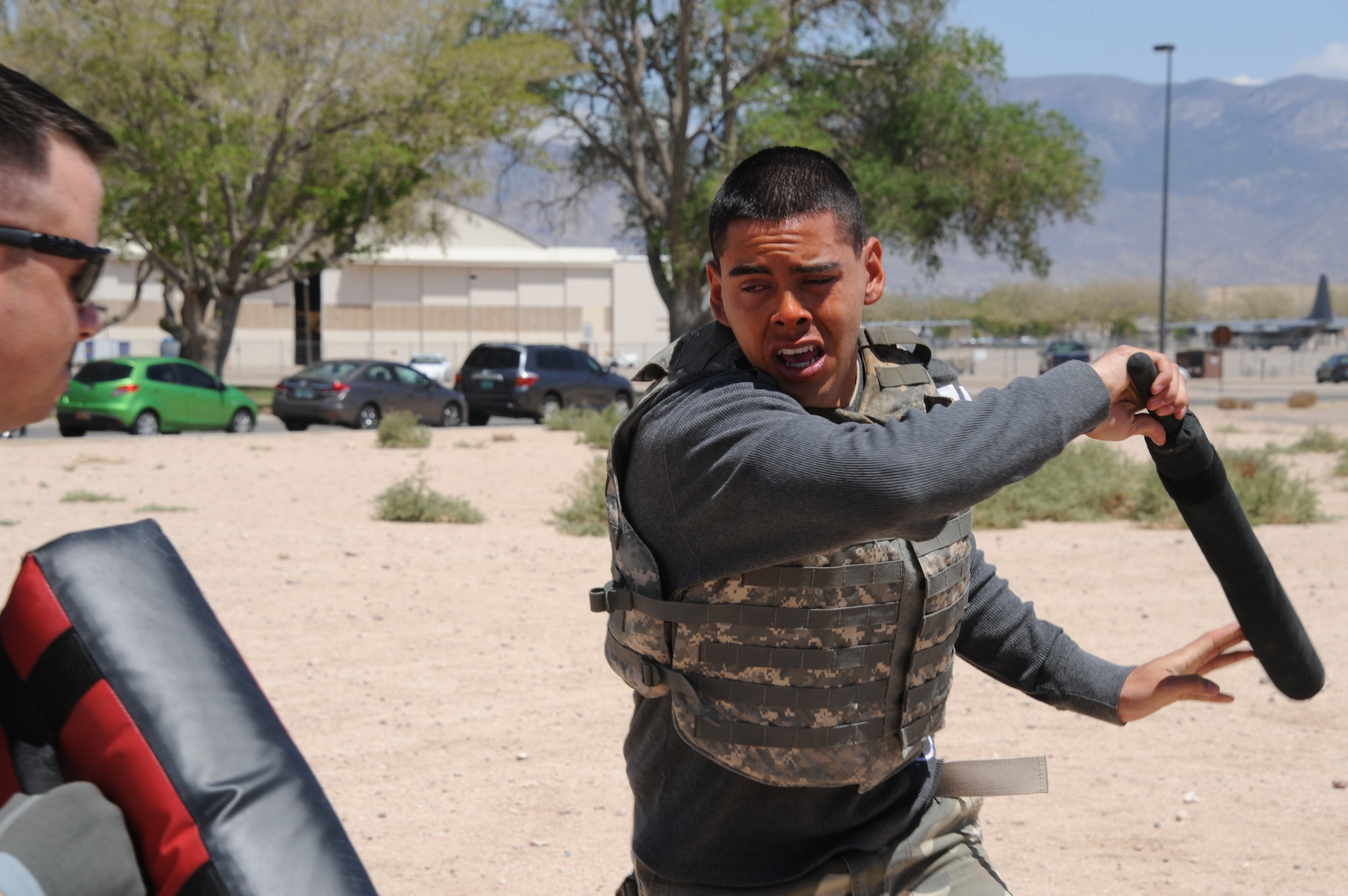 Airmen at the 377th Security Forces Group must undergo pepper spray training to prepare them for real-world scenarios. After being sprayed, Airmen must go through training stages — hand-to-hand combat, using a baton to defend against a combatant and making an arrest. (Photo by Todd Berenger)