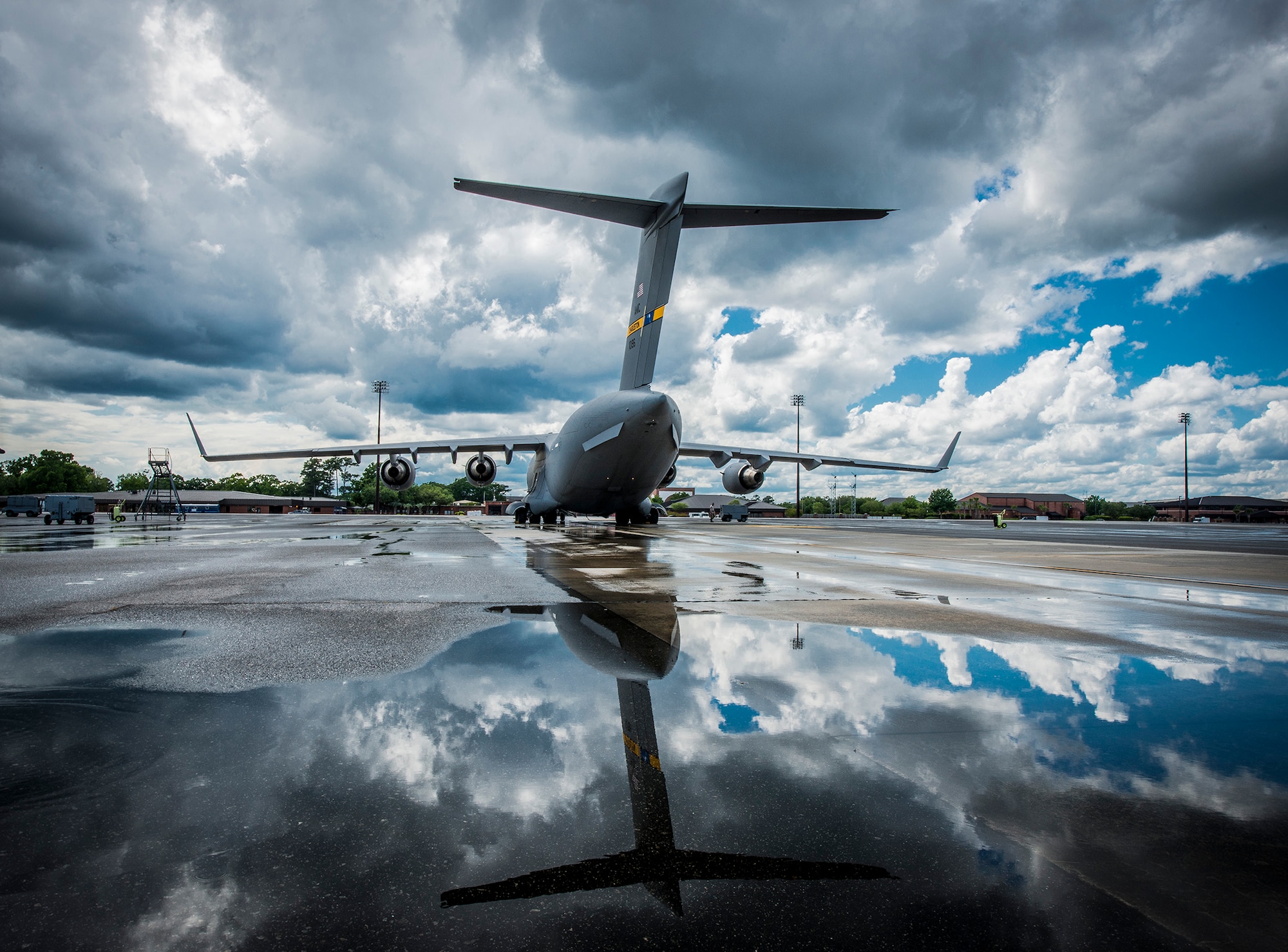 A C-17 Globemaster III assigned to the 437th Airlift Wing sits on the flightline after a rain storm May 7, 2013, at Joint Base Charleston, S.C. The C-17 is capable of rapid strategic delivery of troops and all types of cargo to main operating bases or directly to forward bases in the deployment area. The aircraft can perform tactical airlift and airdrop missions and can transport litters and ambulatory patients during aeromedical evacuations when required. (U.S. Air Force photo/Senior Airman Dennis Sloan)