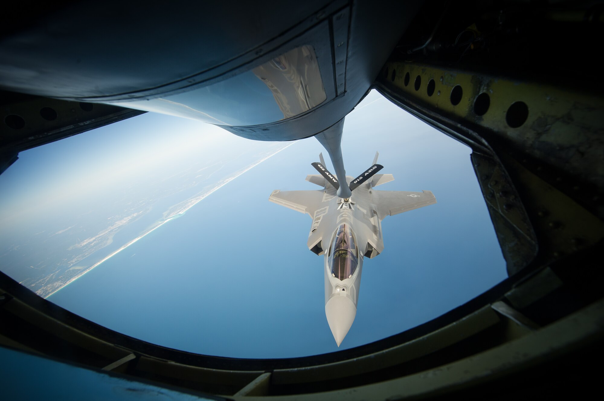 For the first time in Eglin's air space, F-35A Lightning II pilots navigate their aircraft toward an Air Force Reserve KC-135 Stratotanker from the 336th Air Refueling Squadron, March AFB, Calif. The initial cadre of Air Force F-35 instructor pilots at the 33rd Fighter Wing trained with others to qualify in aerial refueling for the joint strike fighter. Their success will add another capability for student pilot training to the F-35 Integrated Training Center here. The 33rd FW is responsible for F-35 A/B/C Lightning II pilot and maintainer training for the Marine Corps, the Navy, the Air Force and, in the future, at least eight coalition partners. Initially, 59 aircraft and three flying squadrons, one for each service/aircraft variant, will be established at Eglin. (U.S. Air Force photo/Master Sgt. John Nimmo)