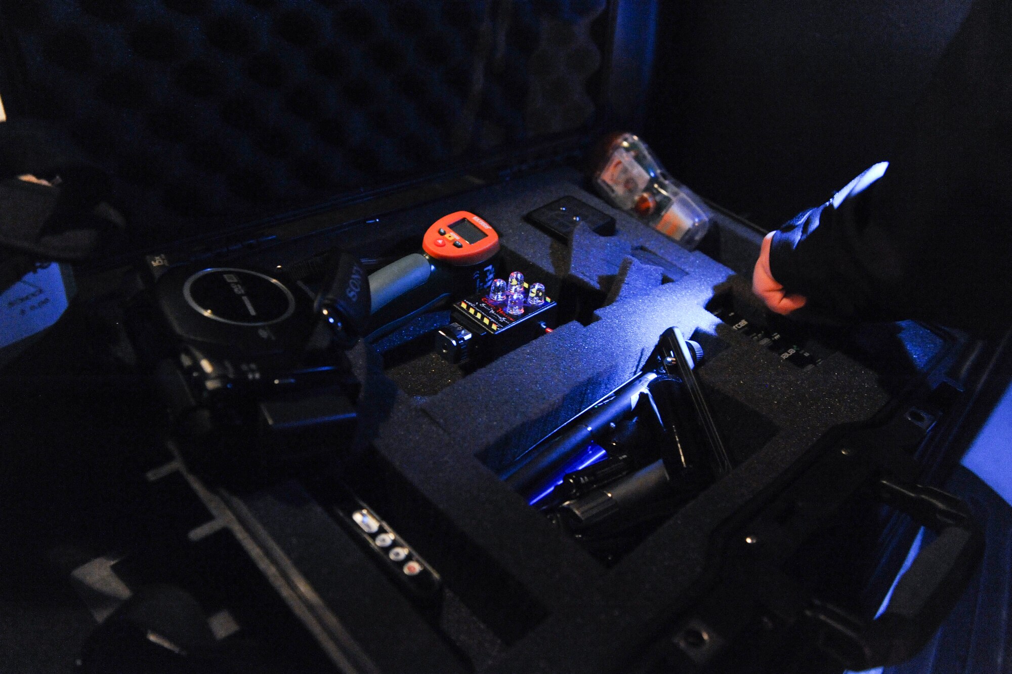 Justin Rangel, a 345th Recruiting Squadron recruiter, prepares equipment prior to beginning a paranormal investigation April 25, 2013, at Camp Nelson Confederate Cemetery in Cabot, Ark. Rangel started investigating the paranormal in 2004. (U.S. Air Force photo by Senior Airman Rusty Frank)