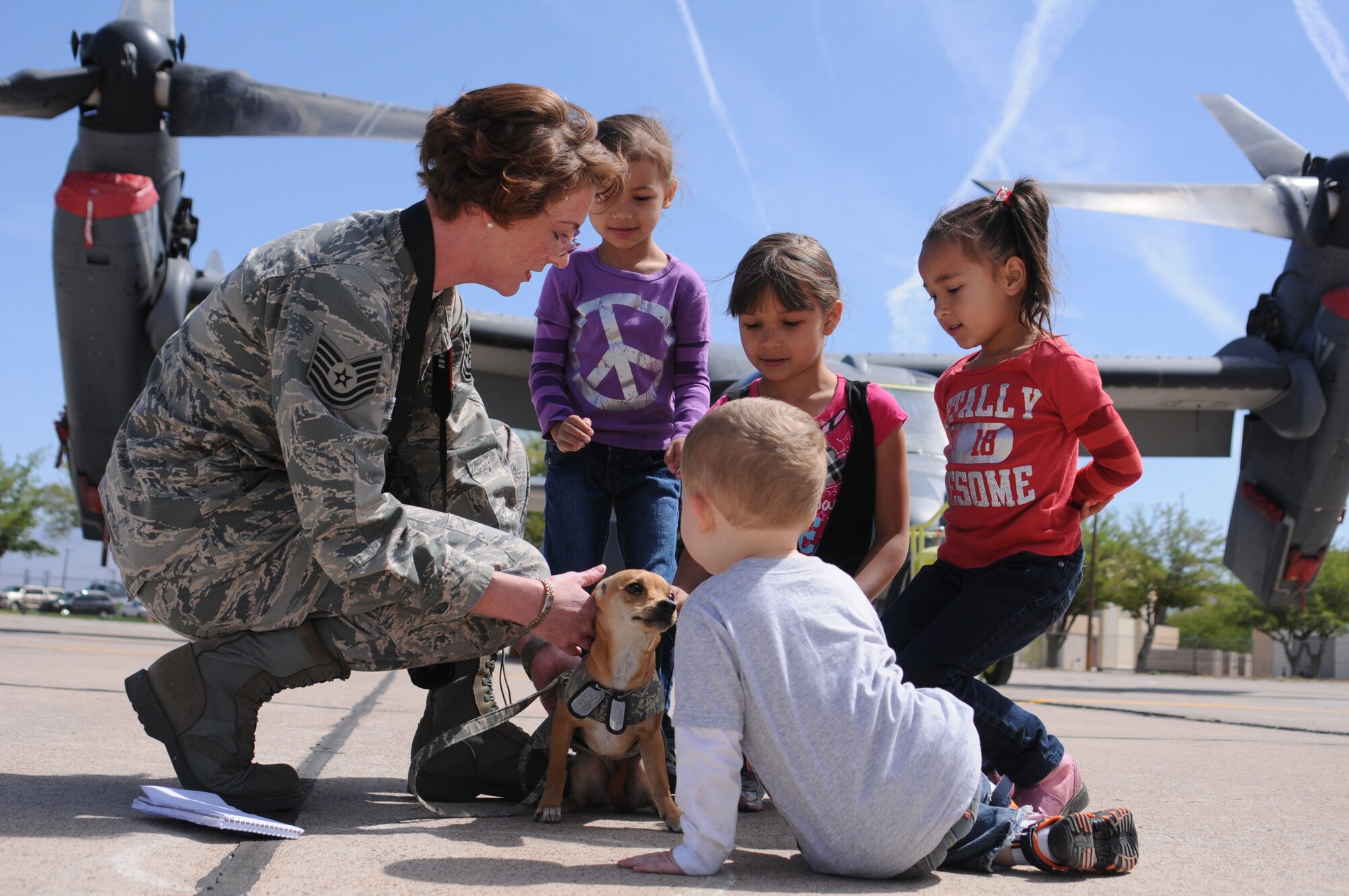 Tech. Sgt. Meredith Mingledorff shares Airman Abby, a chiweenie, with Haylie, 4, Kirsten, 8, Catherine, 6, and Ethyn, 2, at the 58th Special Operations Wing's Spouses Appreciation Day May 4. The girls are the daughters of Tech. Sgt. Lucas Stabe of the 71st Special Operations Squadron, while Ethyn is the son of Master Sgt. Leslie Dye, 58th Operations Group.  More than 500 people attended the event, which was hosted as a way to say thank you for the support given by spouses to those in uniform. (Photo by Tech Sgt. Roberto Bilbao)