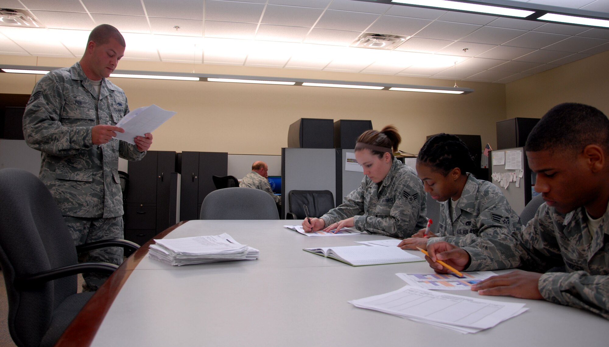 Col. Brian Robinson, 19th Airlift Wing commander, congratulates Staff Sgt. Rick Fox, 19th Maintenance Operations Squadron noncommissioned officer in charge of plans and scheduling, for his selection as Combat Airlifter of the Week April 29, 2013, at Little Rock Air Force Base, Ark. Fox pioneered a Rapid Improvement Event synchronizing the 19th Maintenance Group and 19th Operations Group aircraft scheduling requirements. He developed a single source document eliminating 40 man-hours per week in scheduling updates. (U.S. Air Force photo by Senior Airman Regina Agoha)