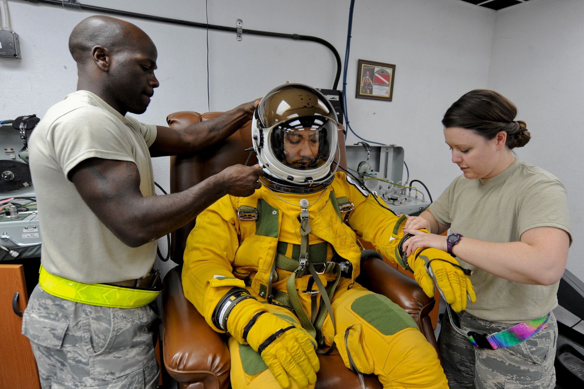 U.S. Air Force Staff Sgt. Joshua Thornton, 99th Expeditionary Reconnaissance Squadron life support technician, and U.S. Air Force Staff Sgt. Heather Doyle, 99th ERS aerospace physiology technician, perform a pre-flight operations check on U.S. Air Force Maj. Patrick Hudson, 99th Expeditionary Reconnaissance Squadron U-2 pilot, prior to his final combat sortie, May 17, 2013, at an undisclosed location in Southwest Asia. Hudson holds the fourth highest number of sortie hours in the U-2 program. Hudson hails from Fayette, Mi., and is deployed from Beale Air Force Base, Calif. Thornton is native to Minden, La., and is also deployed from Beale AFB, as is Doyle. (U.S. Air Force photo by Staff Sgt. Joshua J. Garcia)