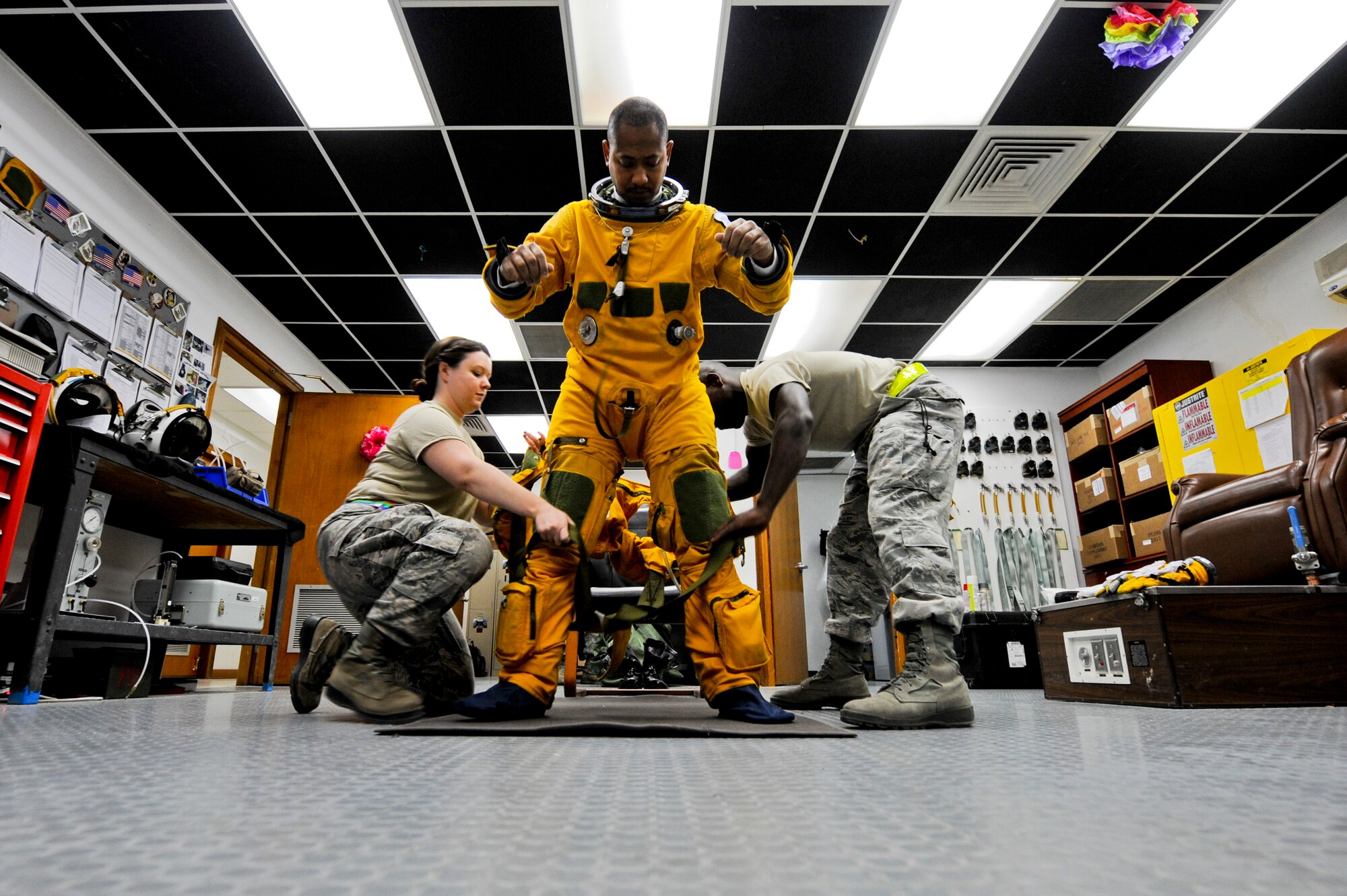 U.S. Air Force Staff Sgt. Heather Doyle, 99th Expeditionary Reconnaissance Squadron aerospace physiology technician, and U.S. Air Force Staff Sgt. Joshua Thornton, 99th ERS life support technician, help U.S. Air Force Maj. Patrick Hudson, 99th ERS U-2 pilot, get into his full pressure suit prior to Hudson's final combat sortie, May 17, 2013, at an undisclosed location in Southwest Asia. Hudson is the 31st pilot in the U-2 program to reach 2,000 U-2 flying hours. Hudson hails from Fayette, Miss., and is deployed from Beale Air Force Base, Calif. Thornton is native to Minden, La., and is also deployed from Beale AFB, as is Doyle. (U.S. Air Force photo by Staff Sgt. Joshua J. Garcia)