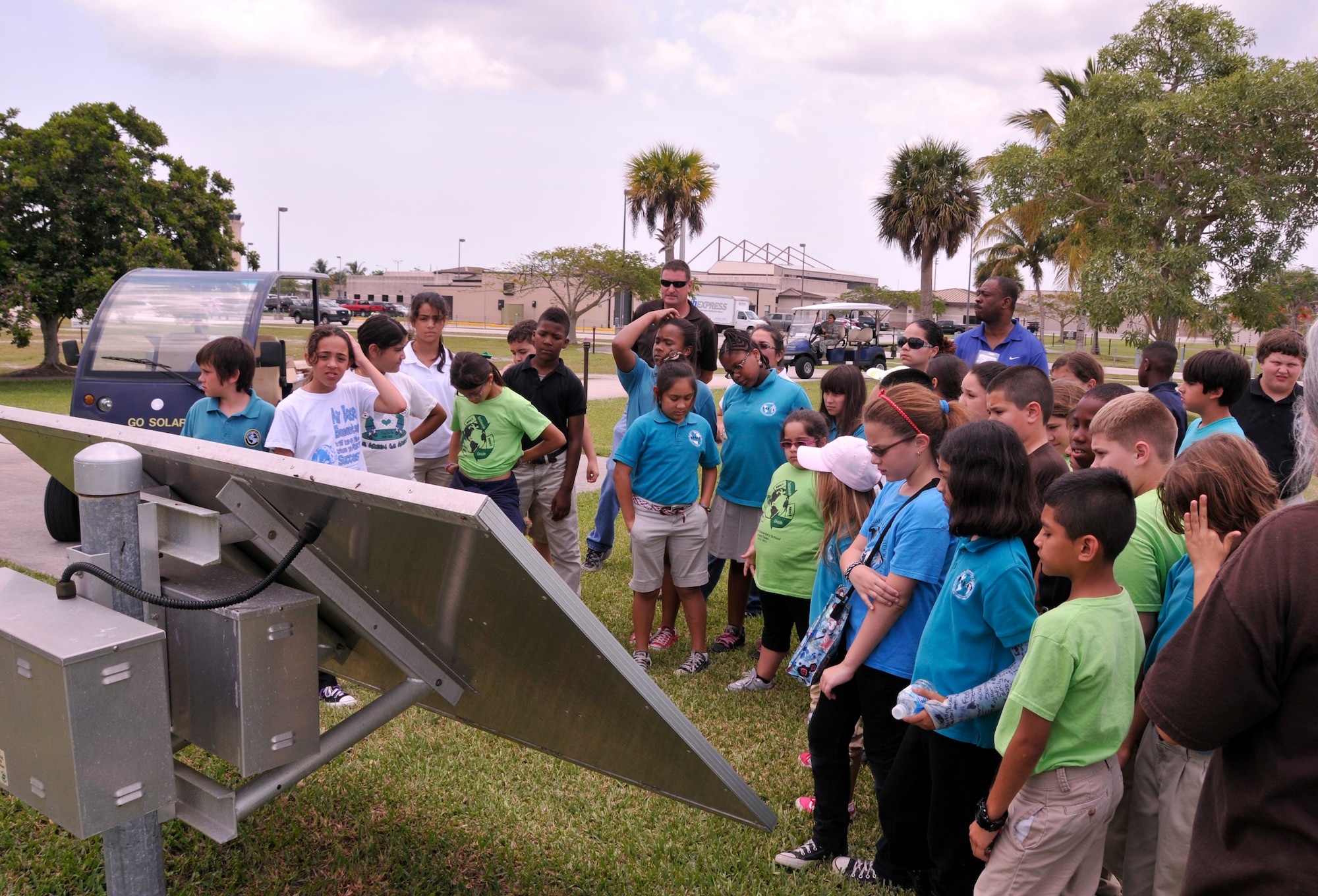 Students from Homestead, Fla.’s Air Base Elementary Green Team gather around a solar panel while Mr. Tim Driscoll, Homestead Air Reserve Base environmental protection specialist, demonstrates how the base utilizes solar power to students during an environmental tour at Homestead Air Reserve Base, Fla., May 13. The environmental tour was conducted as an educational experience for the Green Team in conjunction with Earth Day. The team includes more than 25 children, from grades three through five, who are part of the environmentally focused school club. (U.S. Air Force photo/Senior Airman Nicholas Caceres)