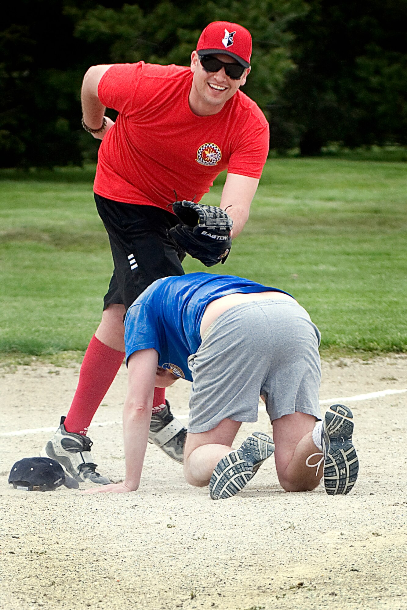 GRISSOM AIR RESERVE BASE, Ind. -- Rob Cosand, 74th Air Refueling Squadron Fightin' Red Tags third baseman, laughs as he tags out a fallen Dark Sider Erik Thorell to end the annual Jovanovich Cup softball game April 27. The 74th Air Refueling Squadron defeated the 72nd ARS 9-5 in the annual game held in memory of Lt. Col. George Jovanovich who died in a car accident in 2006. (U.S. Air Force photo/Tech. Sgt. Doug Hays)