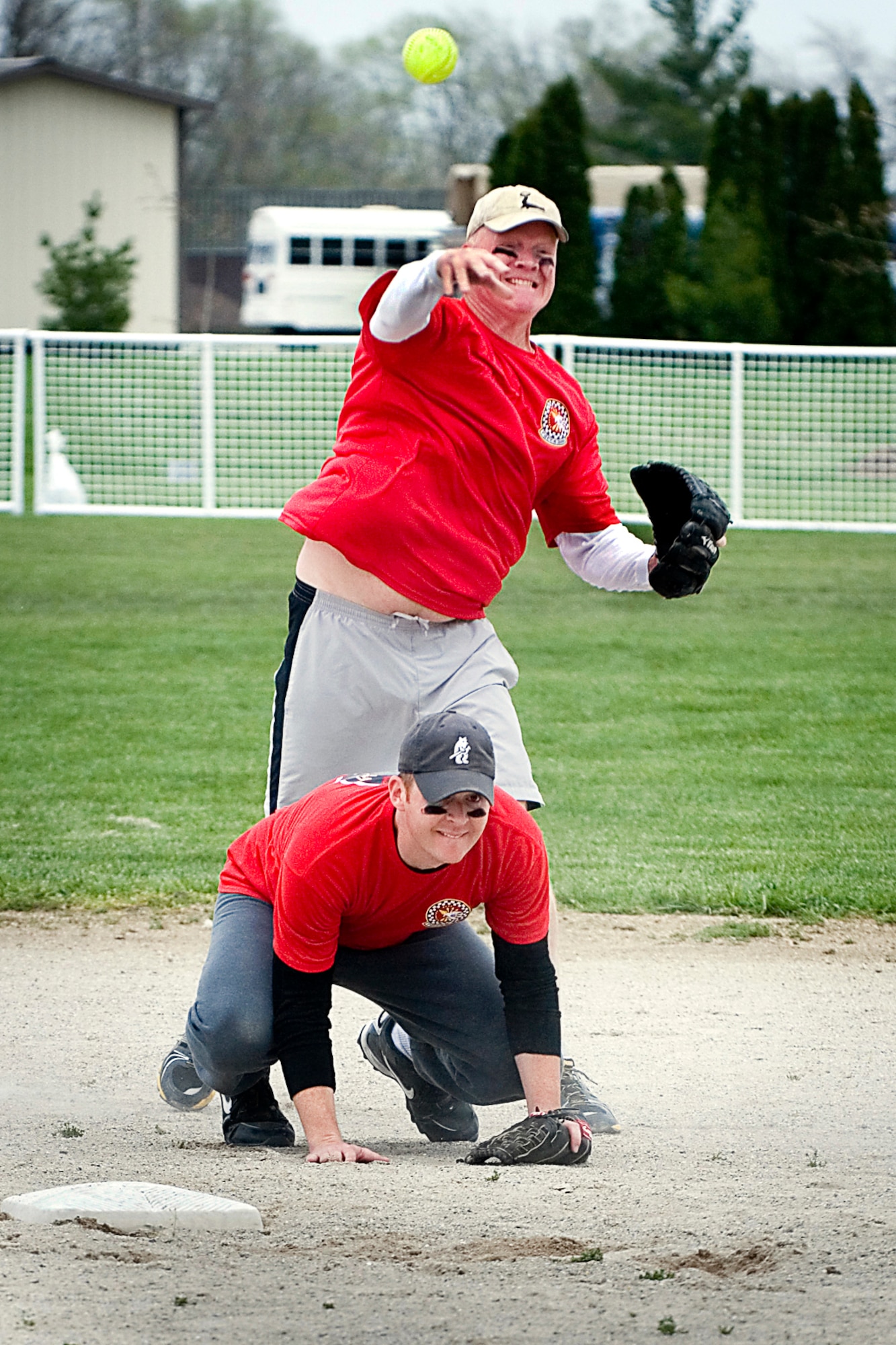 GRISSOM AIR RESERVE BASE, Ind. -- Doug Beck, 74th Air Refueling Squadron Fightin' Red Tags second baseman, throws the ball to first base as Joel Nickelson, shortstop, ducks out of the way during a double play attempt. The duo?s team defeated the 72nd Air Refueling Squadron Dark Side 9-5 to claim the 2013 Jovanovich Cup on April 27. (U.S. Air Force photo/Tech. Sgt. Doug Hays)