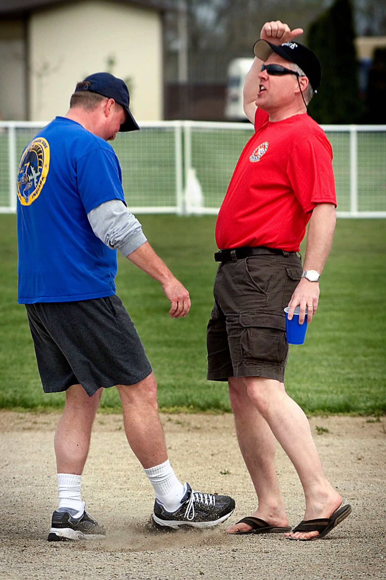 GRISSOM AIR RESERVE BASE, Ind. -- Doug Gullion, 72nd Air Refueling Squadron Dark Side pitcher, shows his frustration for a call by kicking sand on the toes of umpire Paul Wietbrock April 27 during the 7th Annual Jovanovich Cup.  Gullion's Dark Sider team fell to the Fightin' Red Tags 9-5. (U.S. Air Force photo/Tech. Sgt. Doug Hays)