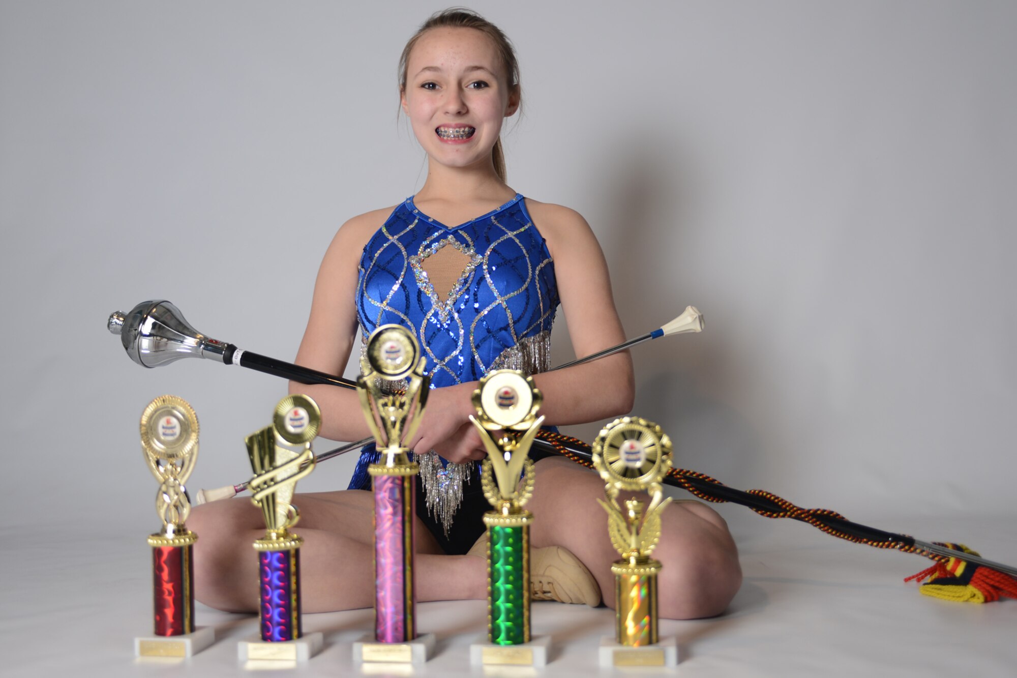 ROYAL AIR FORCE LAKENHEATH, England – Nicolette Gaboriault-Whitcomb, 13, daughter of Lt. Col. Steve Gaboriault-Whitcomb, 48th Aerospace Medicine Squadron bioenvironmental engineering flight commander, poses with her baton, mace and trophies May 14, 2013. Nicolette placed third in fancy strut, second in majorette march, first in flag duo, first in mace solo and first in solo for advance twirl in her age group at the United Kingdom Federation of Majorettes national competition.  (U.S. Air Force photo by Airman 1st Class Dana J. Butler)