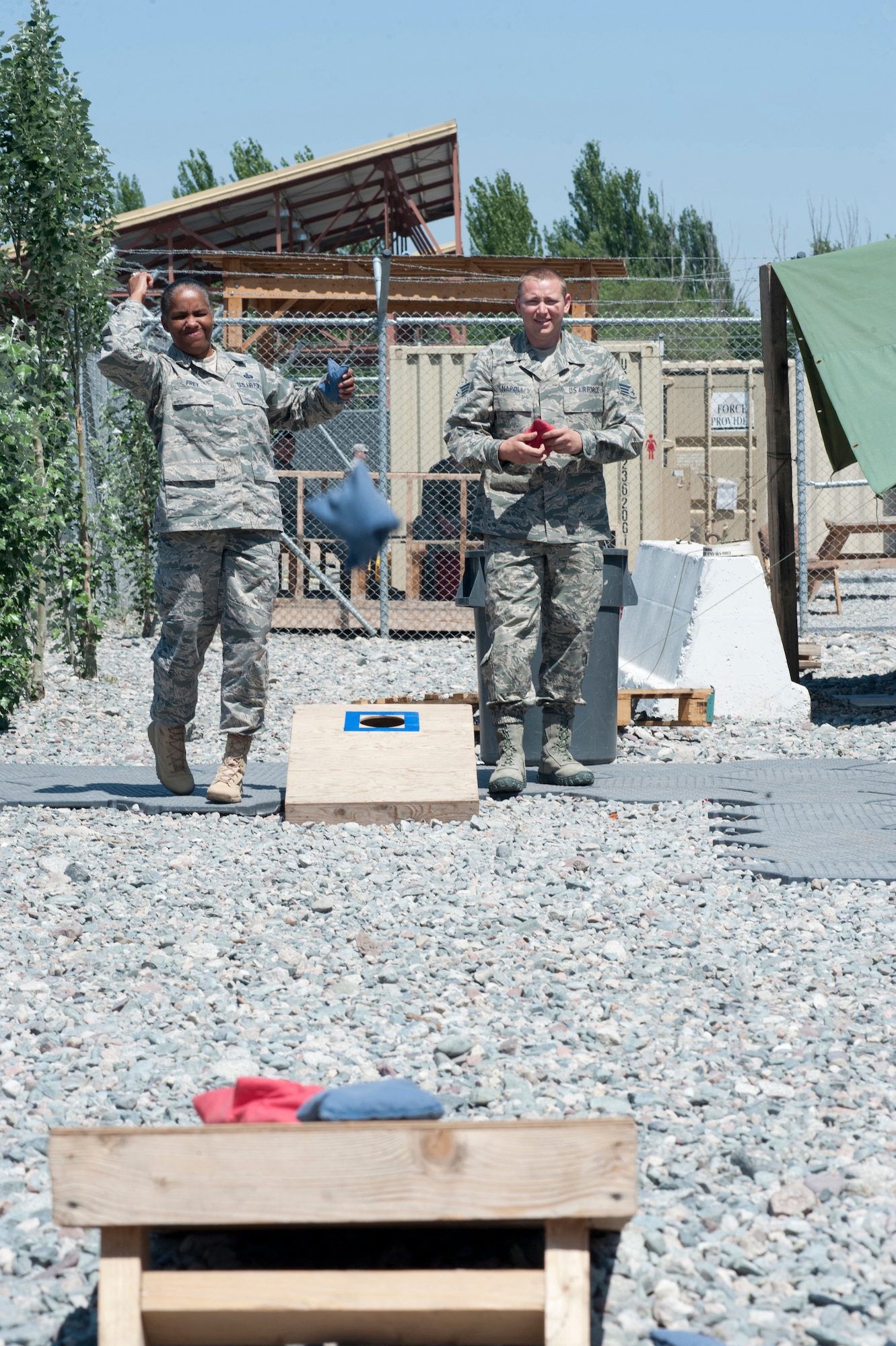 Chief Master Sgt. Shelina Frey, command chief for U.S. Air Forces Central Command, and Senior Airman Joshua Napoli, a member of the 376th Expeditionary Logistics Readiness Squadron, play a bean bag game outside the passenger terminal at Transit Center at Manas, Kyrgyzstan, May 14, 2013. During her visit to the Transit Center, Frey made an effort to engage Airmen in both formal and informal settings. (U.S. Air Force photo/Staff Sgt. Robert Barnett)