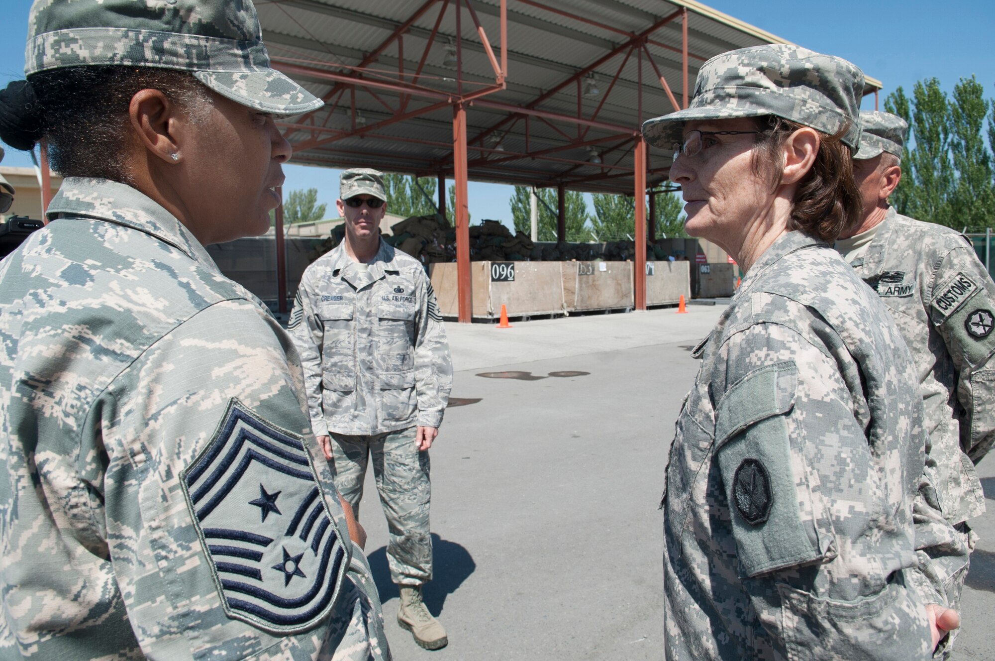 U.S. Army Cpl. Dana Parabeau briefs Chief Master Sgt. Shelina Frey on the customs' mission at Transit Center at Manas, Kyrgyzstan, May 14, 2013. Frey is the new U.S. Air Forces Central Command command chief. Parabeau is the customs flights team leader for the 304th Military Police Battalion, Detachment 5. (U.S. Air Force photo/Staff Sgt. Robert Barnett)