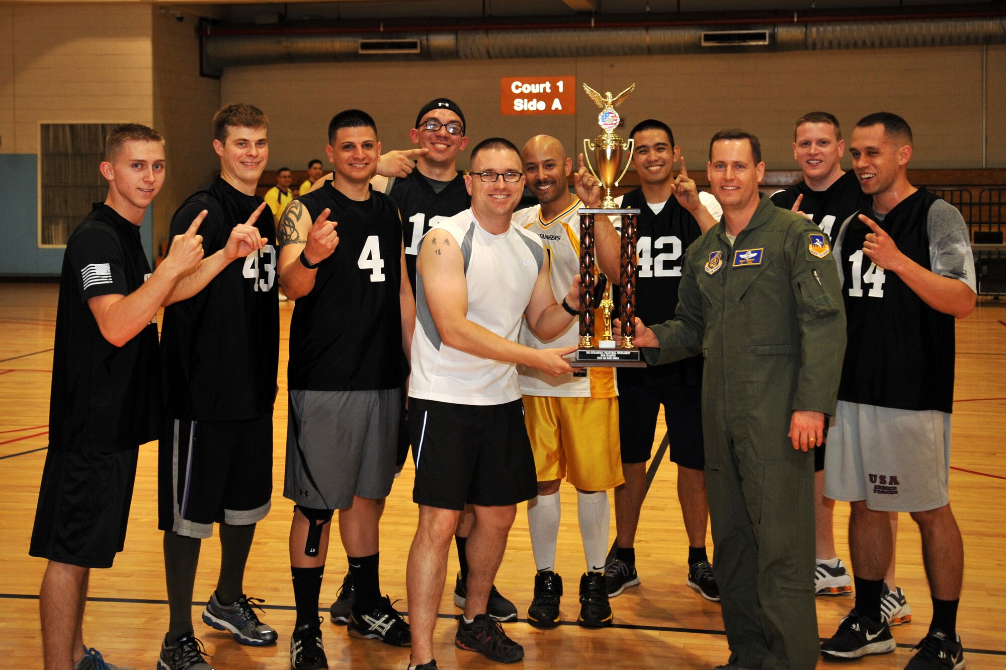 Col. Sean Dewitt (right), 51st Fighter Wing vice commander, presents the 51st Maintenance Squadron intramural volleyball team with the 2013 Intramural Volleyball Championship trophy at Osan Air Base, Republic of Korea, May 15, 2013. The 51st MXS team finished the season with no losses. (U.S. Air Force photo/Staff Sgt. Emerson Nuñez)