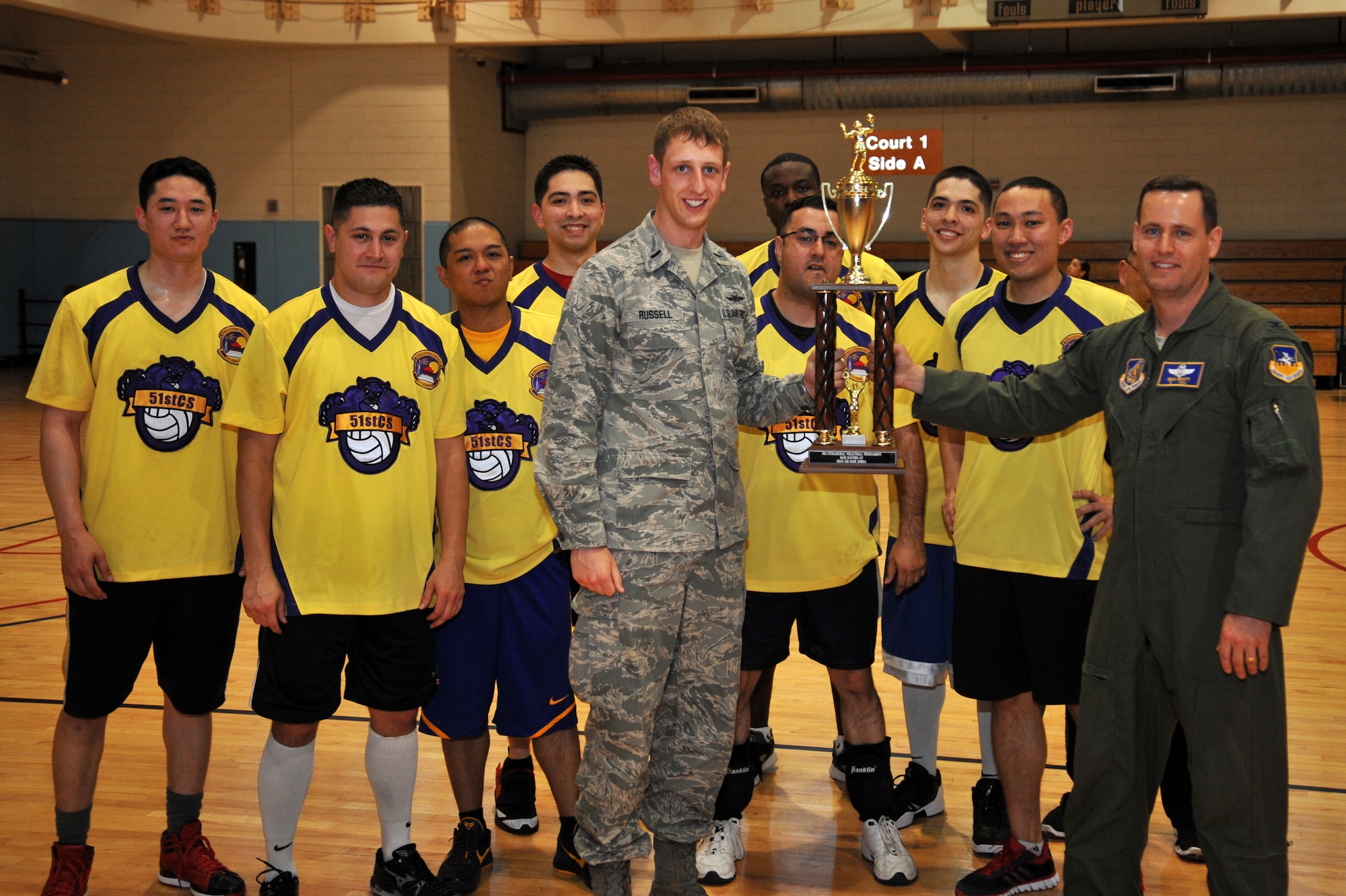 Col. Sean Dewitt (right),  51st Fighter Wing vice commander, presents the 51st Communication Squadron intramural volleyball team with the 2013 Intramural Volleyball runner up trophy at Osan Air Base, Republic of Korea, May 15, 2013. The 51st CS team, who finished the season with eight wins and three losses, fell to the 51st Maintenance Squadron in the championship match. (U.S. Air Force photo/Staff Sgt. Emerson Nuñez)