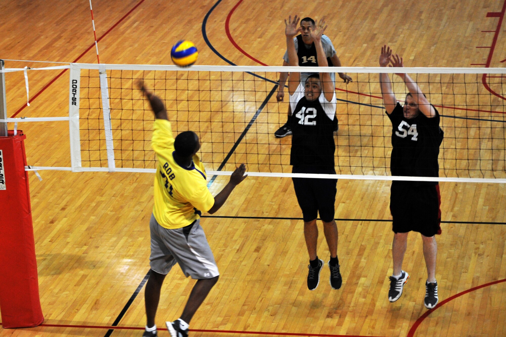 Senior Airman Michael Robinson, 51st Communications Squadron postal clerk, sends back the volleyball during the intramural volleyball championship at Osan Air Base, Republic of Korea, May 15, 2013. The 51st CS team, who finished the season with eight wins and three losses, fell to the 51st Maintenance Squadron in the championship match. (U.S. Air Force photo/Staff Sgt. Emerson Nuñez)