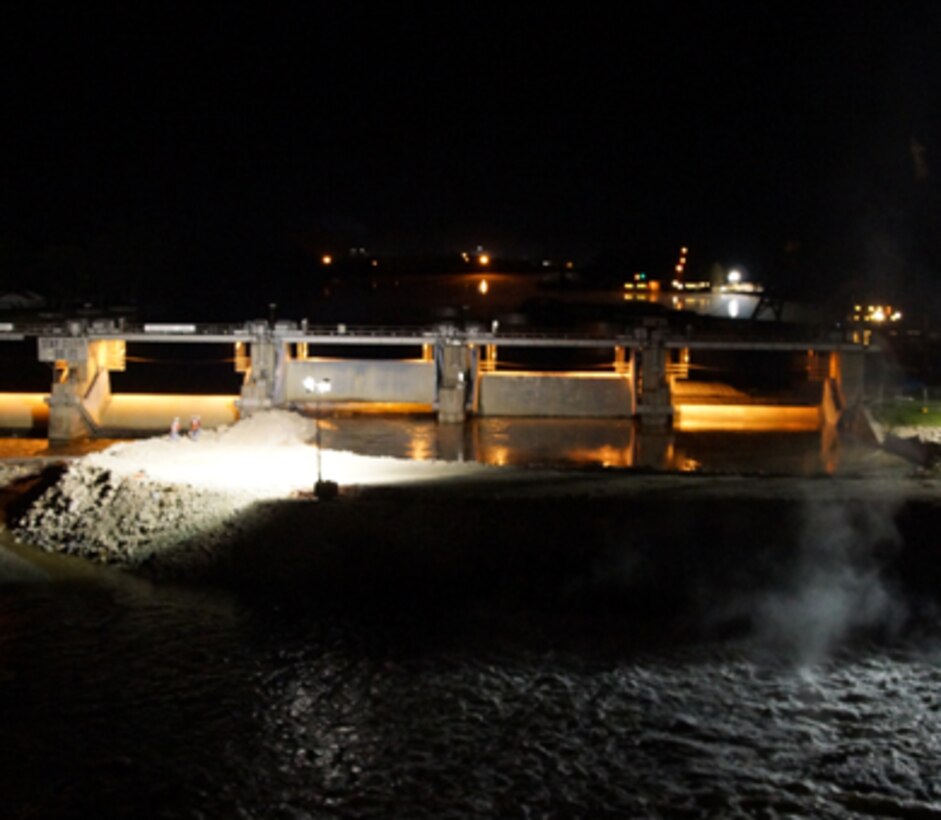 The Army Corps of Engineers built a temporary rock dike just below Marseilles Dam on the Illinois River to reduce river flows and facilitate repairs to the dam. The dike was constructed using approximately 42,000 tons of rock and stretches more than 300 feet. 