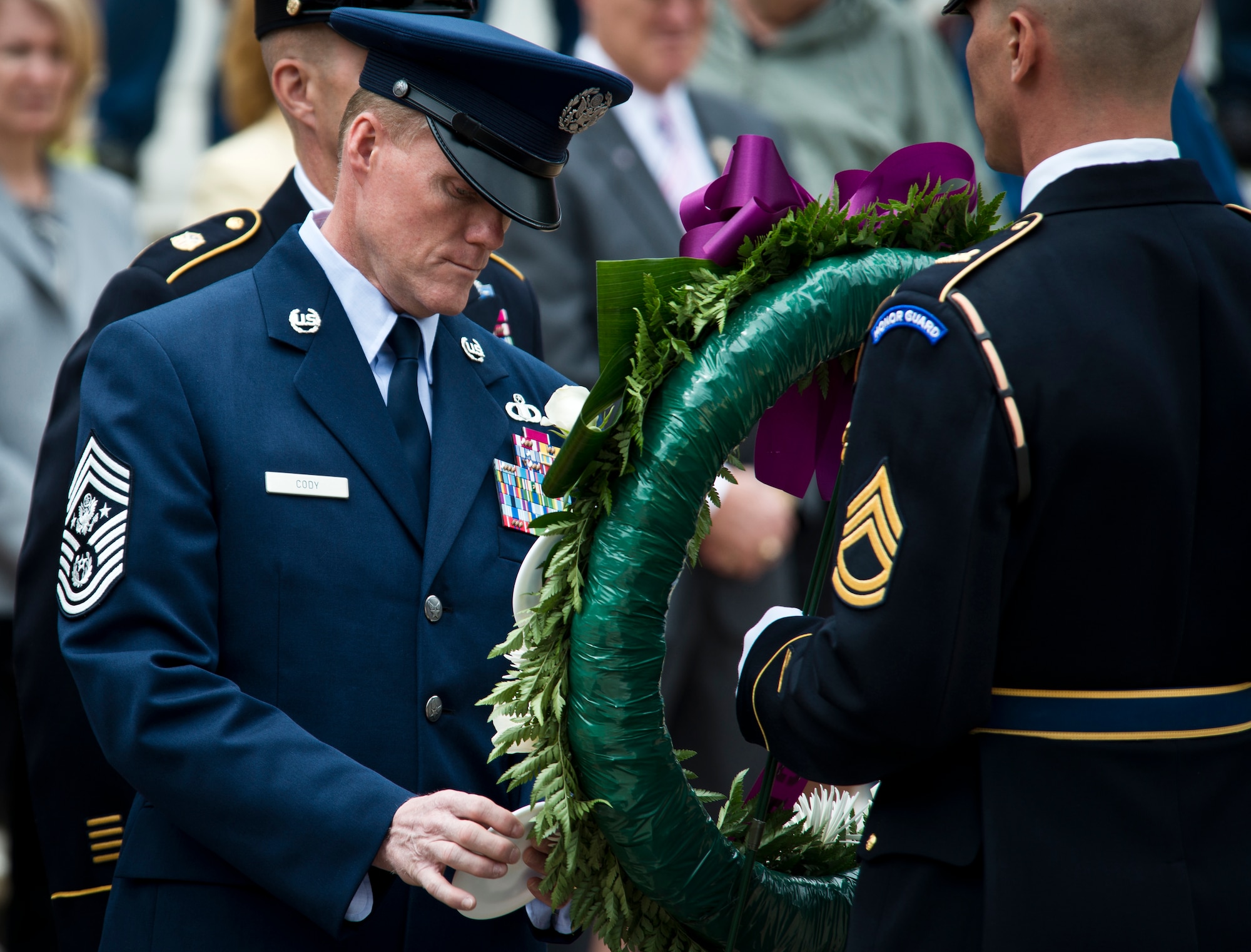 Chief Master Sgt. of the Air Force James A. Cody places a service crest on a wreath in honor of Airmen’s sacrifices during the inaugural Armed Forces Day wreath-laying ceremony May 18, 2013, at the Tomb of the Unknown Soldier at Arlington National Cemetery, Va. Cody along with the senior enlisted advisers from the Army, Navy, Marine Corps,and Coast Guard hung logos of their service on a wreath wrapped with purple ribbon just steps away from the gravesite. (U.S. Air Force photo/Senior Airman Andrew Lee)