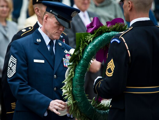 Chief Master Sgt. of the Air Force James A. Cody places a service crest on a wreath in honor of Airmen’s sacrifices during the inaugural Armed Forces Day wreath-laying ceremony May 18, 2013, at the Tomb of the Unknown Soldier at Arlington National Cemetery, Va. Cody along with the senior enlisted advisers from the Army, Navy, Marine Corps,and Coast Guard hung logos of their service on a wreath wrapped with purple ribbon just steps away from the gravesite. (U.S. Air Force photo/Senior Airman Andrew Lee)