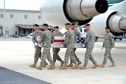 A U.S. Army carry team transfers the remains of Army Cpl. Dwayne W. Flores of Sinajana, Guam, at Dover Air Force Base, Del. on May 18, 2013. Flores was assigned to Company B, 1st Battalion, 294th Infantry, Fort Juan Muna, Guam. (U.S. Air Force photo/David Tucker)

