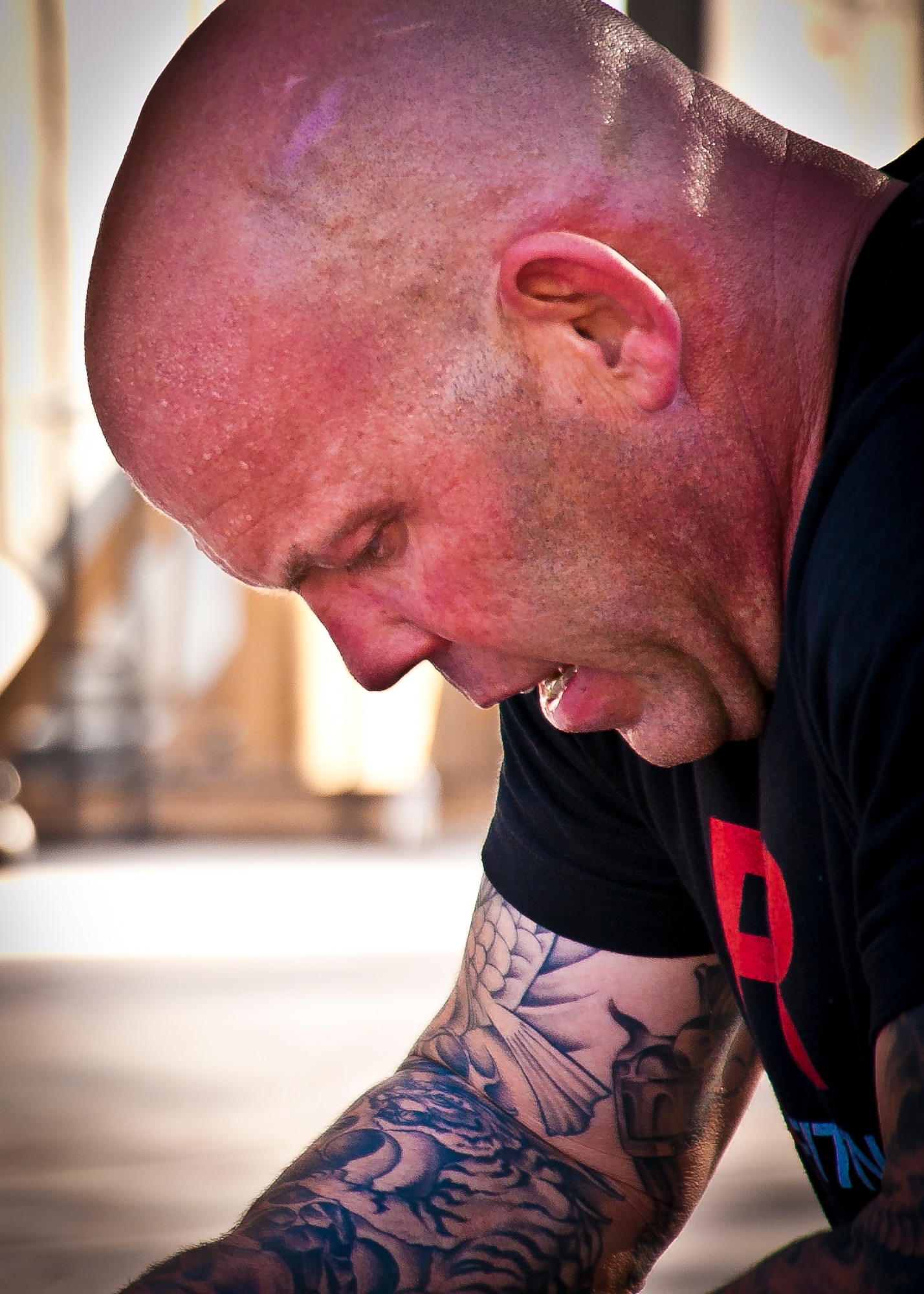 A participant at Kandahar CrossFit Hero Workout of the Day stops to catch his breath during the work-out session at Kandahar Airfield, Afghanistan, May 11, 2013. The WoD was held in honor of the four 361st Expeditionary Reconnaissance Squadron members who gave their lives when their MC-12 Liberty aircraft went down April 27 in Southern Afghanistan. (U.S. Air Force photo/Senior Airman Scott Saldukas)
