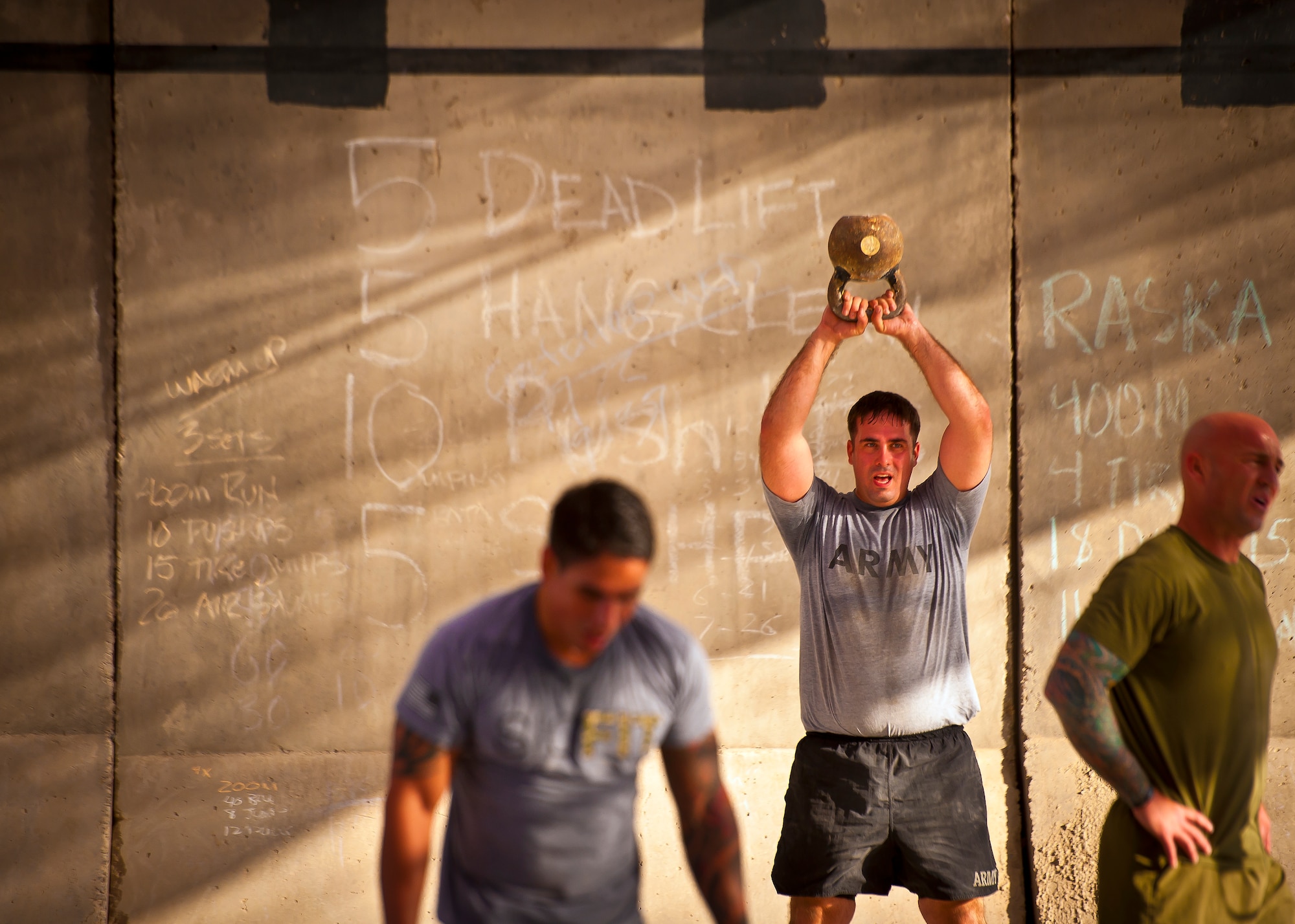 Athletes perform a variety of physically demanding exercises during a Kandahar CrossFit Hero Workout of the Day at Kandahar Airfield, Afghanistan, May 11, 2013. The WoD was held in honor of the four 361st Expeditionary Reconnaissance Squadron members who gave their lives when their MC-12 Liberty aircraft went down April 27 in Southern Afghanistan. (U.S. Air Force photo/Senior Airman Scott Saldukas)