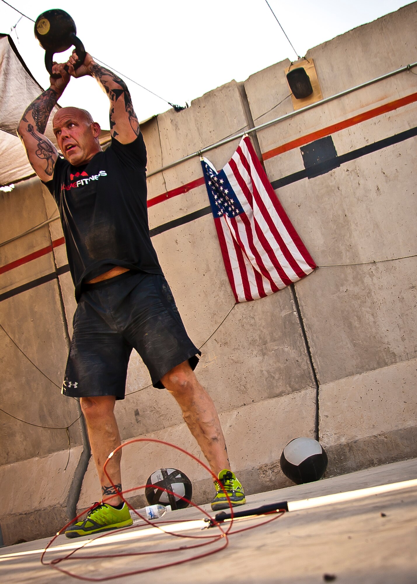 An athlete performs kettle bell swings during a Kandahar CrossFit Hero Workout of the Day at Kandahar Airfield, Afghanistan, May 11, 2013. Participants performed 28 kettle bell swings in remembrance of Capt. Brandon Cyr’s age. Cyr was one of the four 361st Expeditionary Reconnaissance Squadron members who gave their lives when their MC-12 Liberty aircraft went down April 27 in Southern Afghanistan. (U.S. Air Force photo/Senior Airman Scott Saldukas)