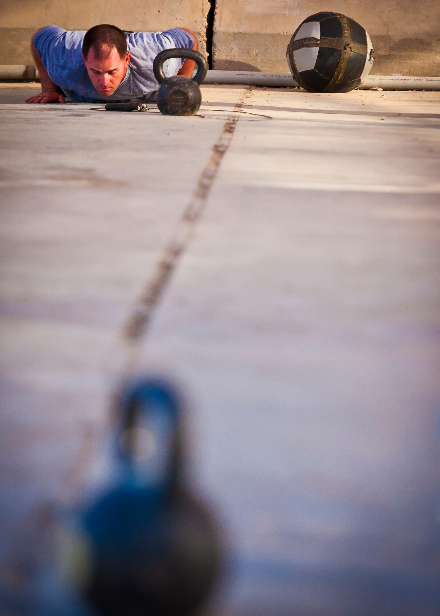 A Soldier pushes up from a burpee during a Kandahar CrossFit Hero Workout of the Day at Kandahar Airfield, Afghanistan, May 11, 2013. Participants performed 27 burpees to remember the day, April 27 when four 361st Expeditionary Reconnaissance Squadron members gave their lives when their MC-12 Liberty aircraft went down April 27 in Southern Afghanistan. (U.S. Air Force photo/Senior Airman Scott Saldukas)
