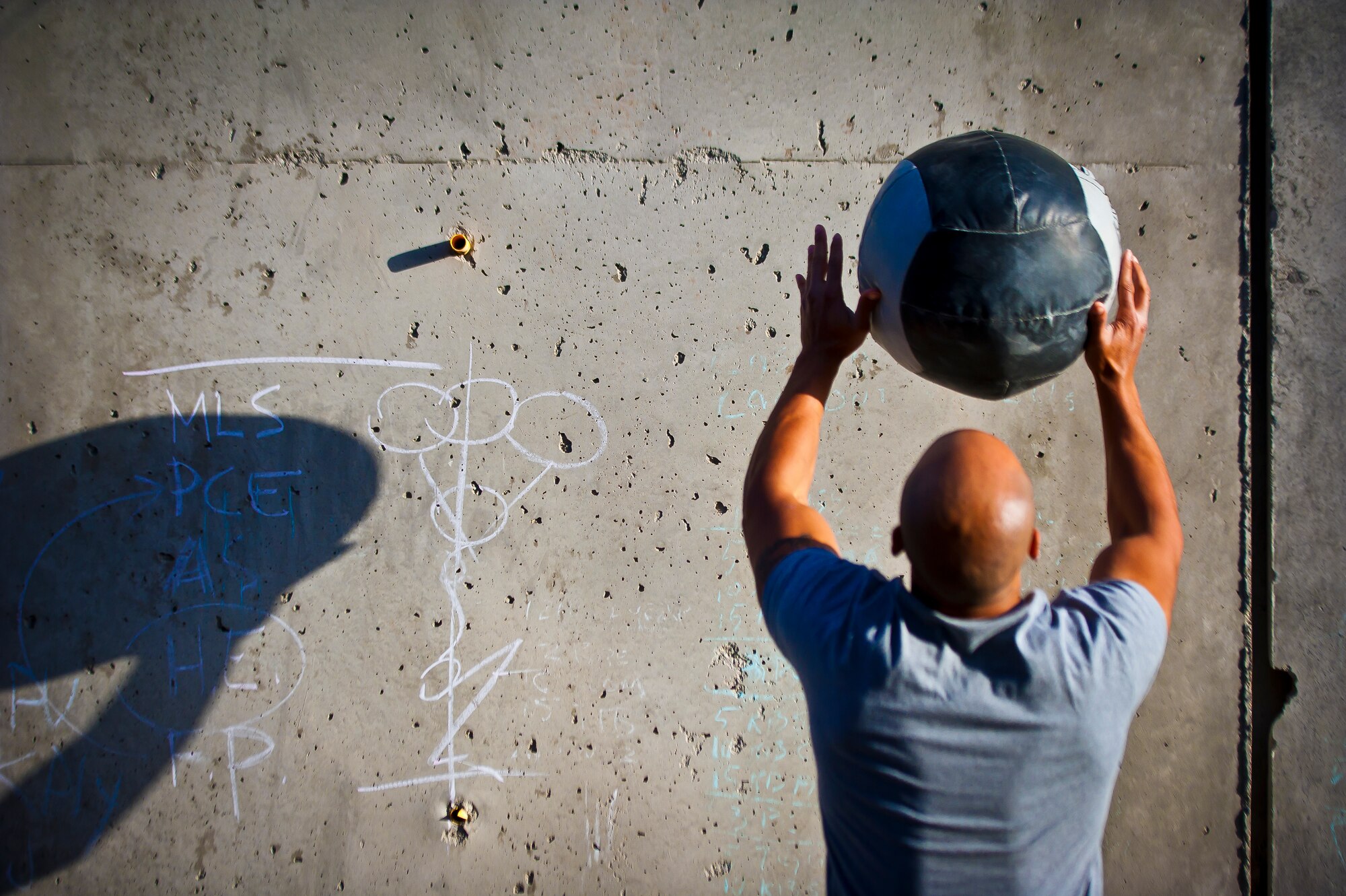 A sportsperson performs a “wall ball” exercise during a Kandahar CrossFit Hero Workout of the Day at Kandahar Airfield, Afghanistan, May 11, 2013. Participants performed 24 wall balls in honor of Staff Sgt. Richard Dickson, who was 24 when the MC-12 Liberty aircraft he was in went down April 27 in Southern Afghanistan. (U.S. Air Force photo/Senior Airman Scott Saldukas)