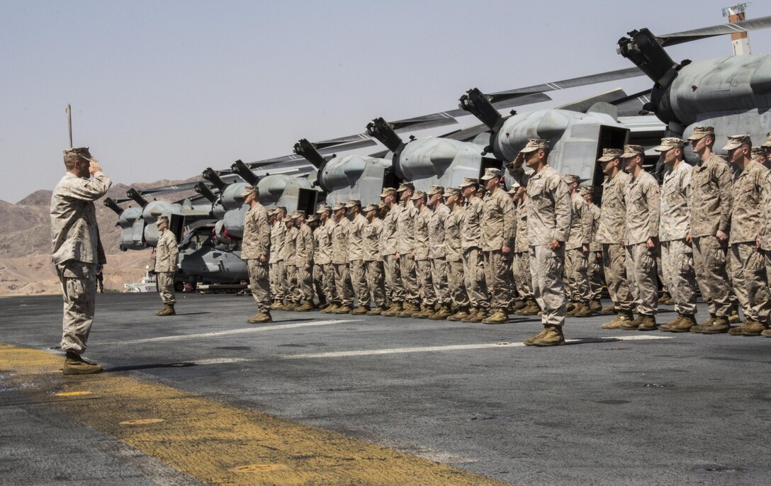 U.S. Marines with Battalion Landing Team 3/2, 26th Marine Expeditionary Unit (MEU), stand in formation for Sgt. Timothy J. Comeau Purple Heart ceremony for wounds received in action Feb. 23, 2011, in Afghanistan on the flight deck of the USS Kearsarge (LHD 3), Eilat, Israel, May 14, 2013. The 26th MEU is deployed to the 5th Fleet area of operations aboard the Kearsarge Amphibious Ready Group. The 26th MEU operates continuously across the globe, providing the president and unified combatant commanders with a forward-deployed, sea-based quick reaction force. The MEU is a Marine Air-Ground Task Force capable of conducting amphibious operations, crisis response and limited contingency operations. (U.S. Marine Corps photograph by Gunnery Sgt. Michael Kropiewnicki/26th MEU Combat Camera/Released)