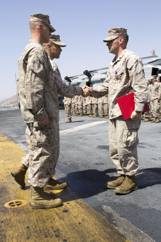 U.S. Marine Sgt. Timothy J. Comeau, Battalion Landing Team 3/2, 26th Marine Expeditionary Unit (MEU) is awarded the Purple Heart for wounds received in action Feb. 23, 2011, in Afghanistan on the flight deck of the USS Kearsarge (LHD 3), Eilat, Israel, May 14, 2013. The 26th MEU is deployed to the 5th Fleet area of operations aboard the Kearsarge Amphibious Ready Group. The 26th MEU operates continuously across the globe, providing the president and unified combatant commanders with a forward-deployed, sea-based quick reaction force. The MEU is a Marine Air-Ground Task Force capable of conducting amphibious operations, crisis response and limited contingency operations. (U.S. Marine Corps photograph by Gunnery Sgt. Michael Kropiewnicki/26th MEU Combat Camera/Released)