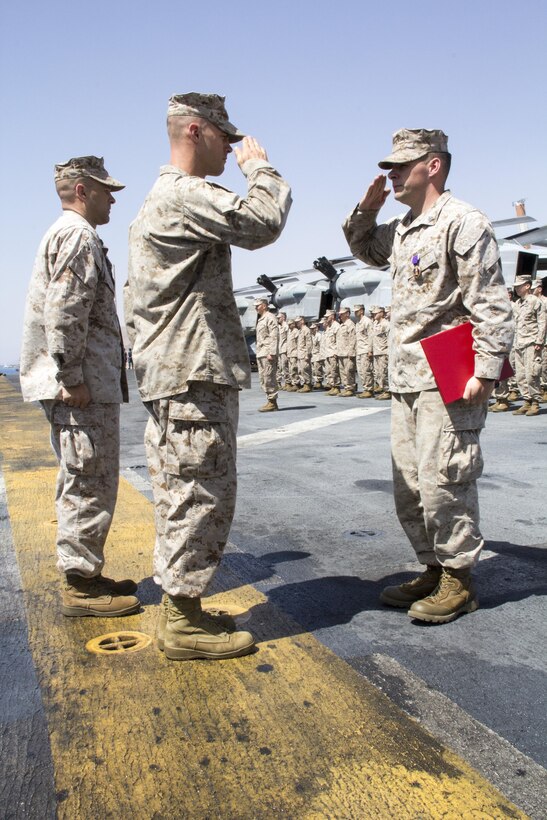 U.S. Marine Sgt. Timothy J. Comeau, Battalion Landing Team 3/2, 26th Marine Expeditionary Unit (MEU) is awarded the Purple Heart for wounds received in action Feb. 23, 2011, in Afghanistan on the flight deck of the USS Kearsarge (LHD 3), Eilat, Israel, May 14, 2013. The 26th MEU is deployed to the 5th Fleet area of operations aboard the Kearsarge Amphibious Ready Group. The 26th MEU operates continuously across the globe, providing the president and unified combatant commanders with a forward-deployed, sea-based quick reaction force. The MEU is a Marine Air-Ground Task Force capable of conducting amphibious operations, crisis response and limited contingency operations. (U.S. Marine Corps photograph by Gunnery Sgt. Michael Kropiewnicki/26th MEU Combat Camera/Released)