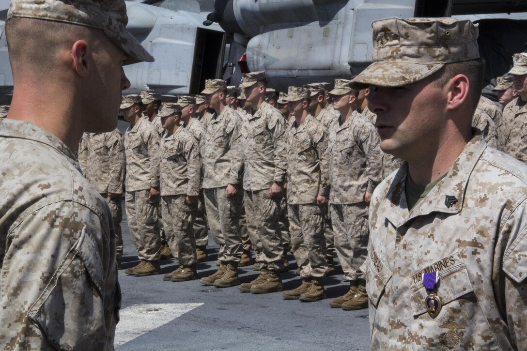 U.S. Marine Sgt. Timothy J. Comeau, Battalion Landing Team 3/2, 26th Marine Expeditionary Unit (MEU) is awarded the Purple Heart for wounds received in action Feb. 23, 2011, in Afghanistan on the flight deck of the USS Kearsarge (LHD 3), Eilat, Israel, May 14, 2013. The 26th MEU is deployed to the 5th Fleet area of operations aboard the Kearsarge Amphibious Ready Group. The 26th MEU operates continuously across the globe, providing the president and unified combatant commanders with a forward-deployed, sea-based quick reaction force. The MEU is a Marine Air-Ground Task Force capable of conducting amphibious operations, crisis response and limited contingency operations. (U.S. Marine Corps photograph by Gunnery Sgt. Michael Kropiewnicki/26th MEU Combat Camera/Released)