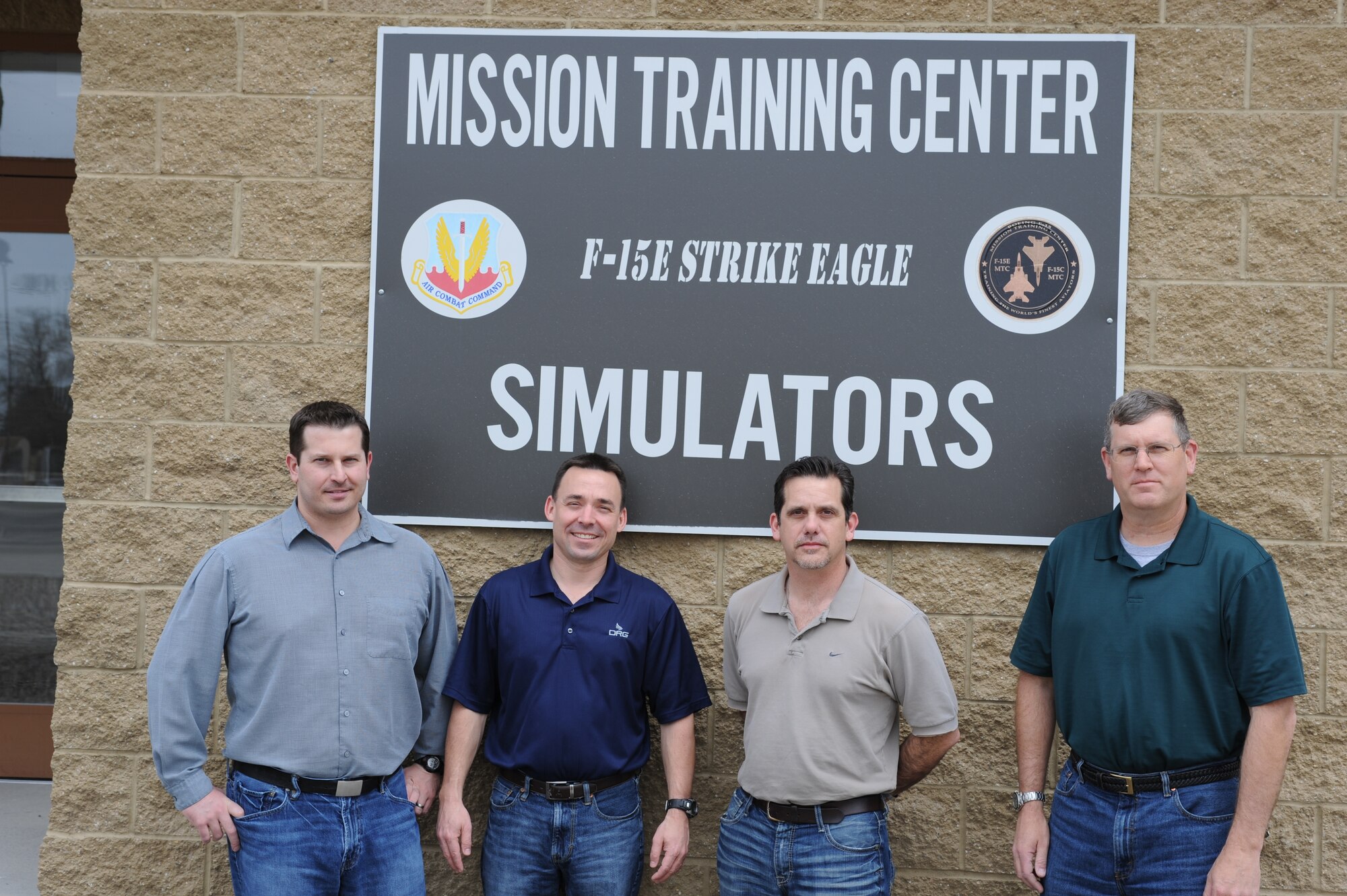 Personnel from the 366th Operations Support Squadron mission training center stand outside the simulator building April 17, 2013, at Mountain Home Air Force Base, Idaho. The 366th Fighter Wing stood down the 391st Fighter Squadron "Bold Tigers" as part of the United States Air Force’s decision to curtail flying operations for active duty combat units April 10, 2013, and the simulators have been used consistently ever since in order to ensure the squadron's combat mission readiness. (U.S. Air Force photo by Senior Airman Benjamin Sutton/Released)