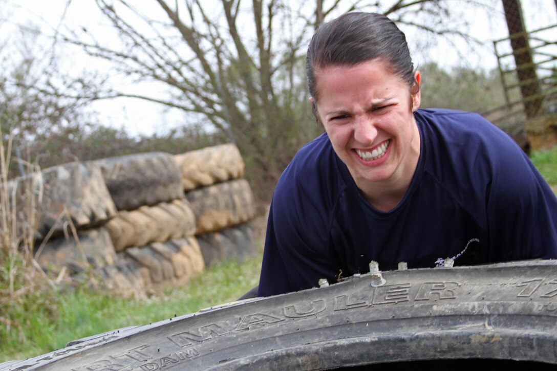 Paige C. Colburn, a poolee with Recruiting Substation Monroe, Recruiting Station Columbia, flips a large tire during an April 3 physical training session in Monroe, N.C. Paige, who joined the Marine Corps Delayed Entry Program on Jan. 22, is scheduled to ship to recruit training on April 8. (Photo by Sgt. Aaron Rooks)   