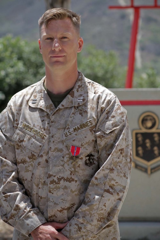 Capt. Benjamin M. Middendorf, the former commanding officer of Golf Company, 2nd Battalion, 5th Marine Regiment, was awarded the Bronze Star Medal with Combat "V" for valor during a ceremony at the 5th Marines Memorial Garden here, May 16, 2013. According to the award citation, Middendorf, a native of Rochester, Minn., led Golf Company into an operation that thwarted an insurgent infiltration attempt in the Musa Qal'ah District Center in Helmand province, Afghanistan, in April 2012. A Marine forward observer was severely wounded during the four-hour firefight that developed during the operation. Despite being directly engaged by heavy machine gun fire, Middendorf continued to direct his Marines to neutralize the enemy and safely executed the medical evacuation of the wounded Marine. A month later, Middendorf led his company on a relentless 14-day operation that pushed out enemy forces from Musa Qal'ah district through constant firefights. Through his leadership, his Marines were directly responsible for neutralizing 160 enemy fighters, destroying 40 enemy bunkers, seizing multiple weapons caches and helping Afghan security forces seize and destroy more than $143,000 worth of narcotics during the 14-day operation.