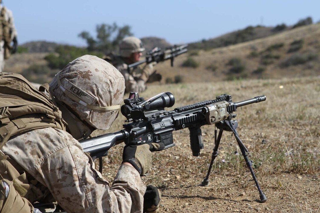 Private First Class Jordan Kemp, a rifleman serving with Bravo Company, 1st Battalion, 1st Marine Regiment, provides suppressive fire during an assault training exercise here, May 15, 2013. The training was designed to give team leaders, and squad leaders practice leading their Marines in combat.