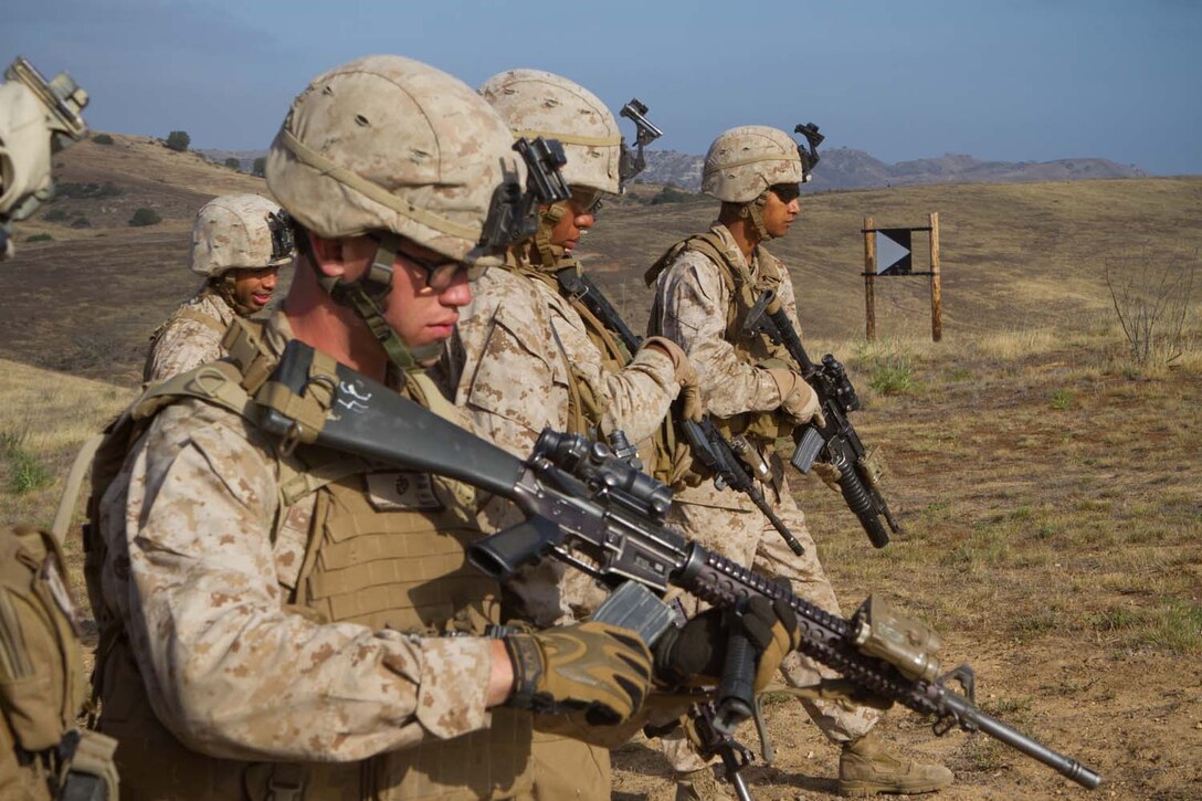 Marines serving with 1st Battalion, 1st Marine Regiment, prepare to start their assault on an enemy position during a training exercise here, May 15, 2013. The training was designed to give fire team leaders and squad leaders practice leading their infantrymen in combat situation.