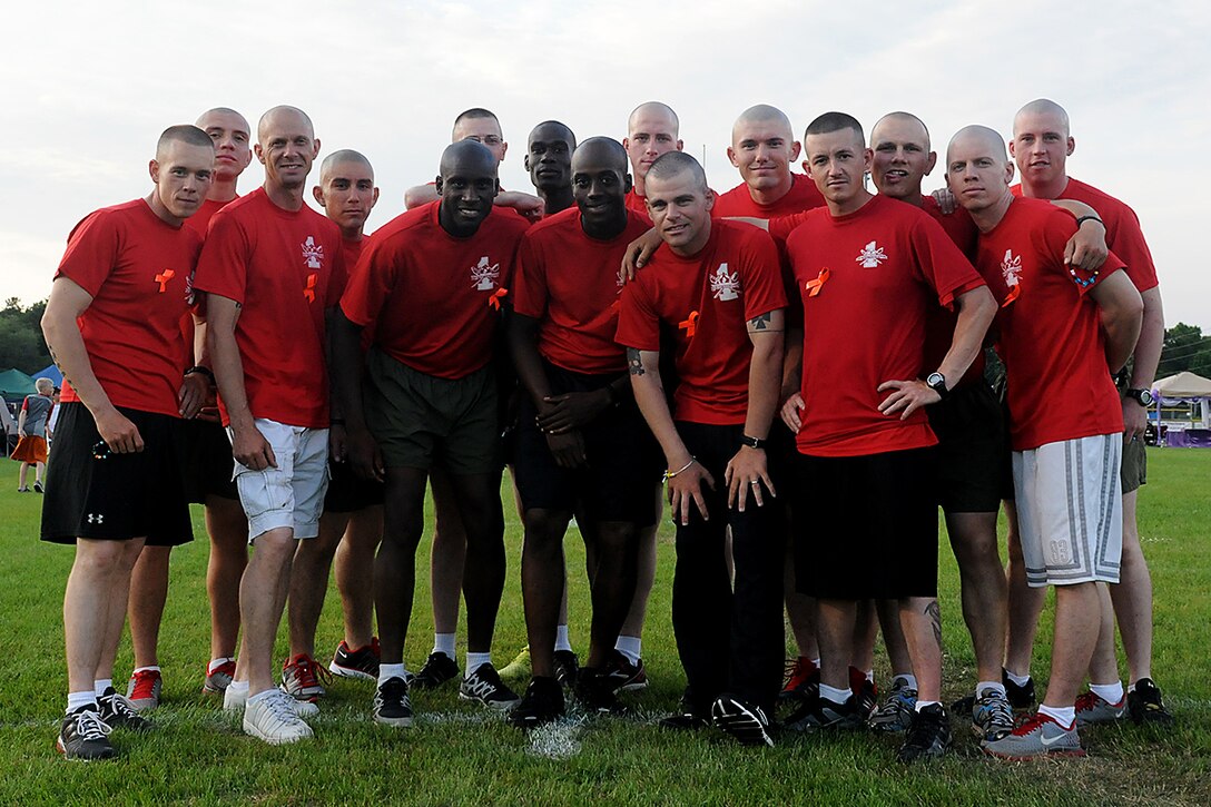 A group of drill instructors from the First Recruit Training Battalion aboard Marine Corps Recruit Depot Parris Island pose for a group photo, while representing the Pacesetter Relay Team at the Relay for Life Event at Battery Creek High School, Beaufort, S.C., May 17, 2013.  At the end of the event, the 92 members of the Pacesetter Relay Team logged a total of 1,550 laps, equivalent to 387.5 miles. With all the statistics combined, the team ranked first place with over 930,000 steps, beating the second place team with a total of 63,000 steps. (U.S. Marine Corps photo by Cpl. Gabrielle Bustos)