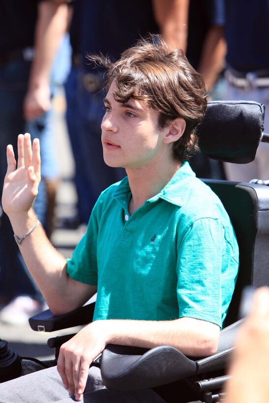 Adam Wolf, 14, recites the oath of enlistment and becomes an honorary service member during the 54th Annual Armed Forces Day Celebration and Parade at Torrance, Calif., May 18. Wolf battles through cerebral palsy, epilepsy, hydrocephalus and a life threatening seizure disorder and has wanted to serve in the United States military since childhood.