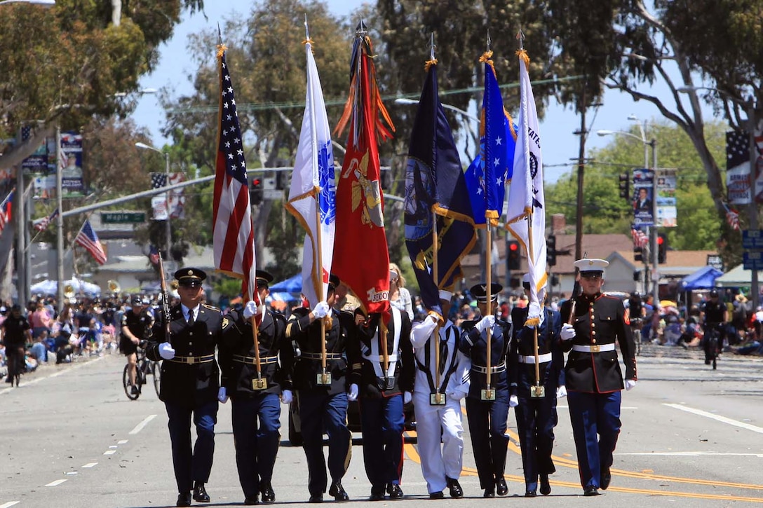 A joint service color guard carries each service flag along with the American flag at the start of the Torrance Armed Forces Day Parade at Torrance, Calif., May 18. The parade is the nation's longest running parade sponsored by any city. Along with parade, the people of Torrance enjoyed a free concert and a military exhibit featuring a variety of military vehicles.