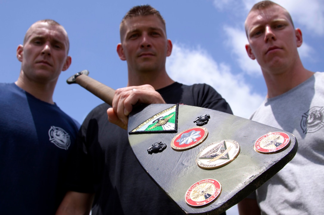 From left, Sgt. Justin Mason, Chief Warrant Officer 2 Clint Hunt, and Sgt. James Armstrong stand with the Headquarters and Headquarters Squadron Paddle after winning a multi-station race during the safety fair and field meet held at Lake O’Neill Recreational Area here May 17. Mason is an administration chief, Hunt is the officer-in-charge, and Armstrong is a motor transportation mechanic, with the squadron here.