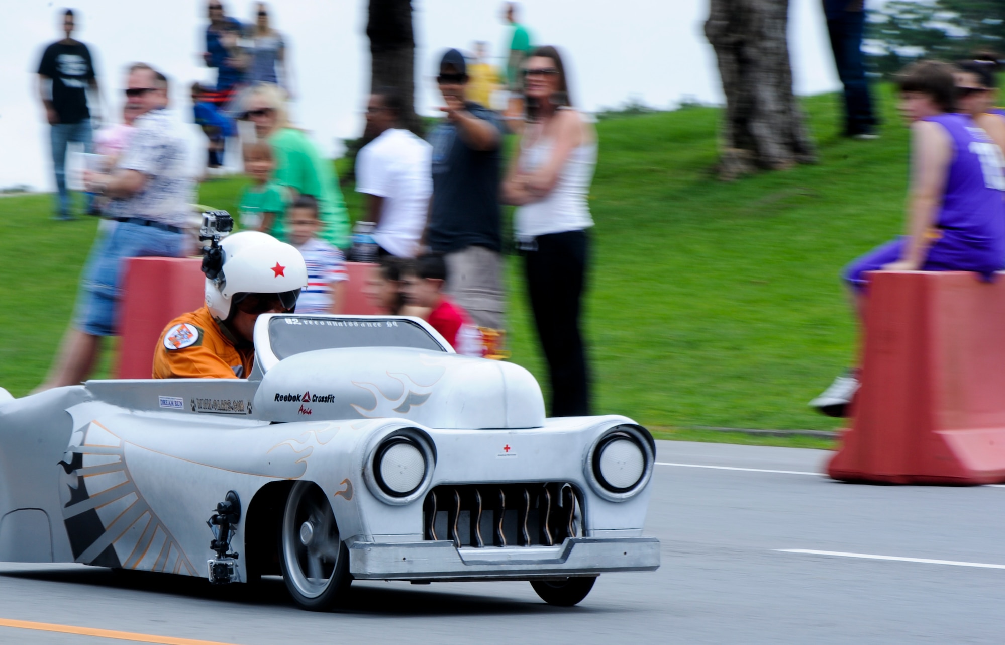 An 82nd Reconnaissance Squadron member drives a customized soap box car during the American Red Cross Derby Day on Kadena Air Base, Japan, May 18, 2013. The 5th Annual Derby Day, which is an island-wide community service project for U.S. service members and their families raised more than $5,000, which will go back into the community in support of American Red Cross volunteer services on Kadena Air Base, White Beach Naval Facility, Torii Station, and Camp Shields. (U.S. Air Force photo by Airman 1st Class Justin Veazie/Released)