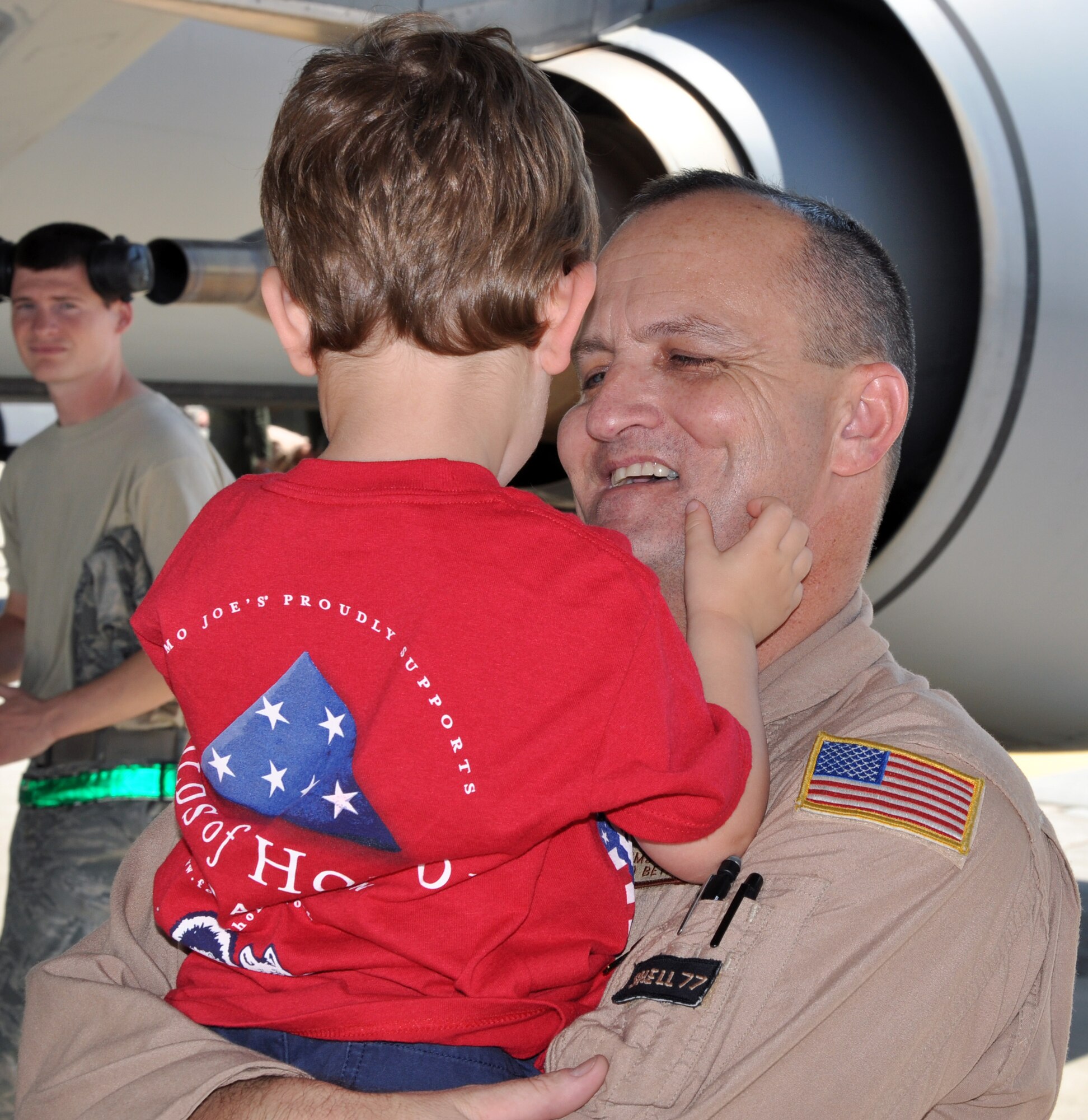 Senior Master Sgt. Brad Beyer, a refueling boom operator assigned to the 18th Air Refueling Squadron, 931st Air Refueling Group, greets his son on the flightline at McConnell Air Force Base, Kan.  Beyer had just returned from a deployment to Southwest Asia, where he conducted refueling missions in support of ongoing U.S. operations overseas.  (U.S. Air Force photo by Capt. Zach Anderson)