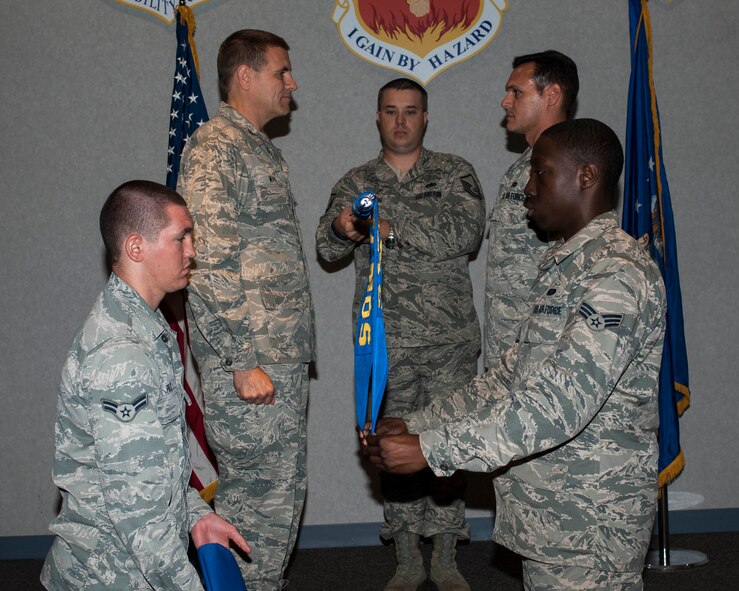 U.S. Air Force Airmen from the 317th Airlift Group furl the 317th Maintenance Operation Squadron (MOS) guidon, symbolizing the end of the squadron's mission May 16, 2013, at Dyess Air Force Base, Texas. The 317th MOS provides management oversight on all fleet health issues, formulates plans, established procedures for and provides training to group maintenance personnel, directs logistics support for all group assigned aircraft/engines through engine management, plans and scheduling. While the 317th MOS is being deactivated, its functions will continue as a designated flight, aligned under the 317th Maintenance Squadron. (U.S. Air Force photo by Airman 1st Class Kylsee Wisseman/Released)